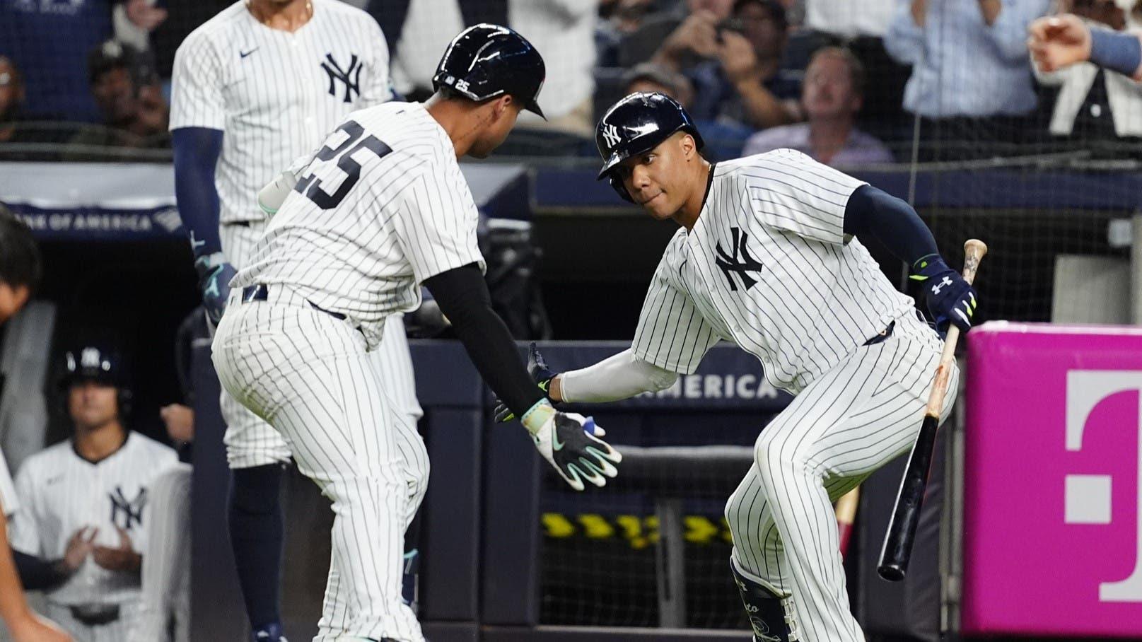 Sep 12, 2024; Bronx, New York, USA; New York Yankees right fielder Juan Soto (22) congratulated New York Yankees second baseman Gleyber Torres (25) for hitting a home run against the Boston Red Sox during the first inning at Yankee Stadium. / Gregory Fisher-Imagn Images