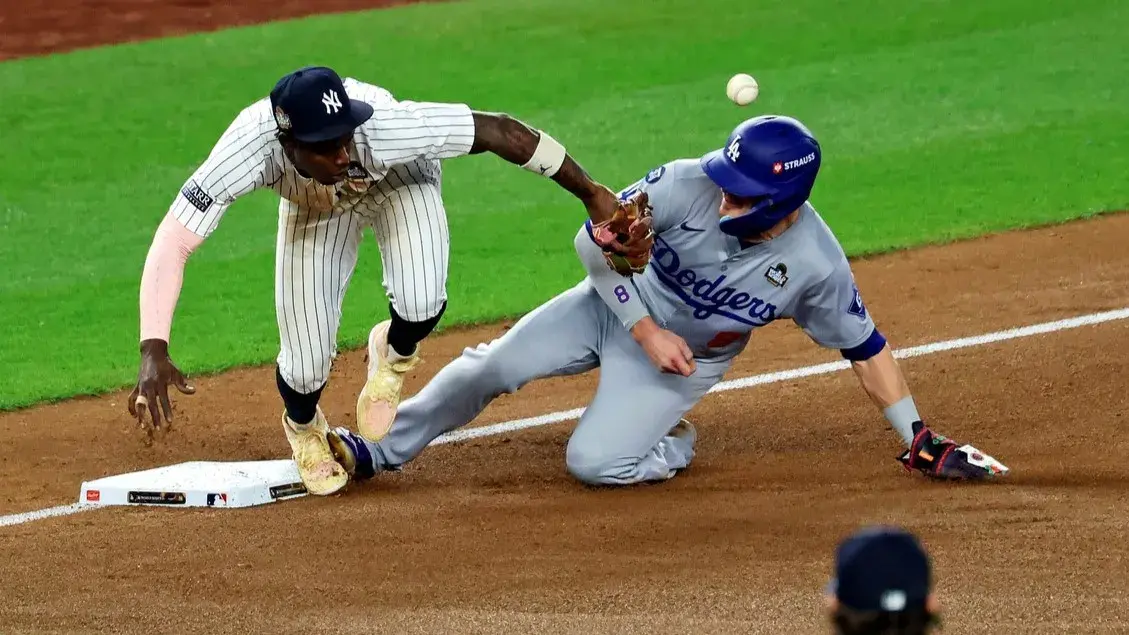 Oct 30, 2024; Bronx, New York, USA; Los Angeles Dodgers third baseman Enrique Hernandez (8) reaches third base after an error by New York Yankees third baseman Jazz Chisholm Jr. (13) during the fifth inning during game five of the 2024 MLB World Series at Yankee Stadium. / James Lang-Imagn Images