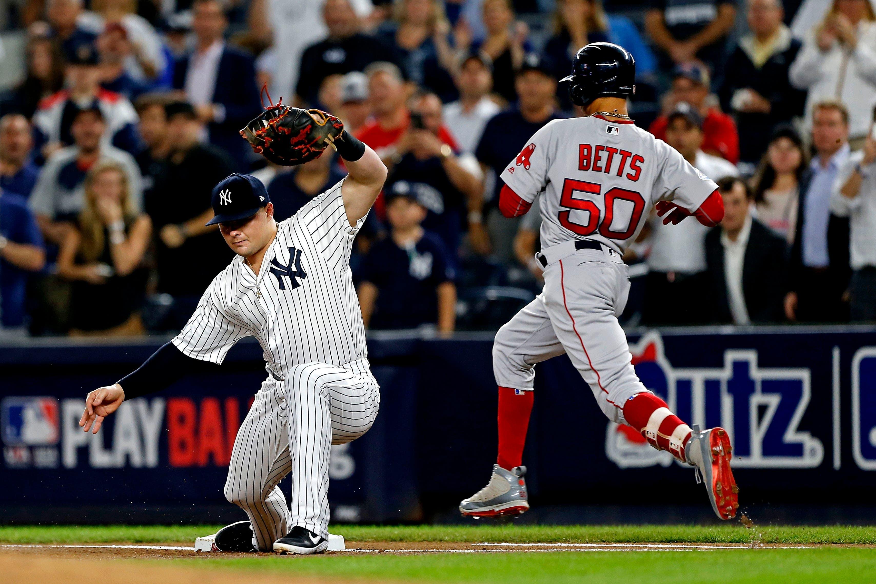 Oct 9, 2018; Bronx, NY, USA; New York Yankees first baseman Luke Voit (45) forces out Boston Red Sox right fielder Mookie Betts (50) during the first inning in game four of the 2018 ALDS playoff baseball series at Yankee Stadium. Mandatory Credit: Noah K. Murray-USA TODAY Sports / Noah K. Murray