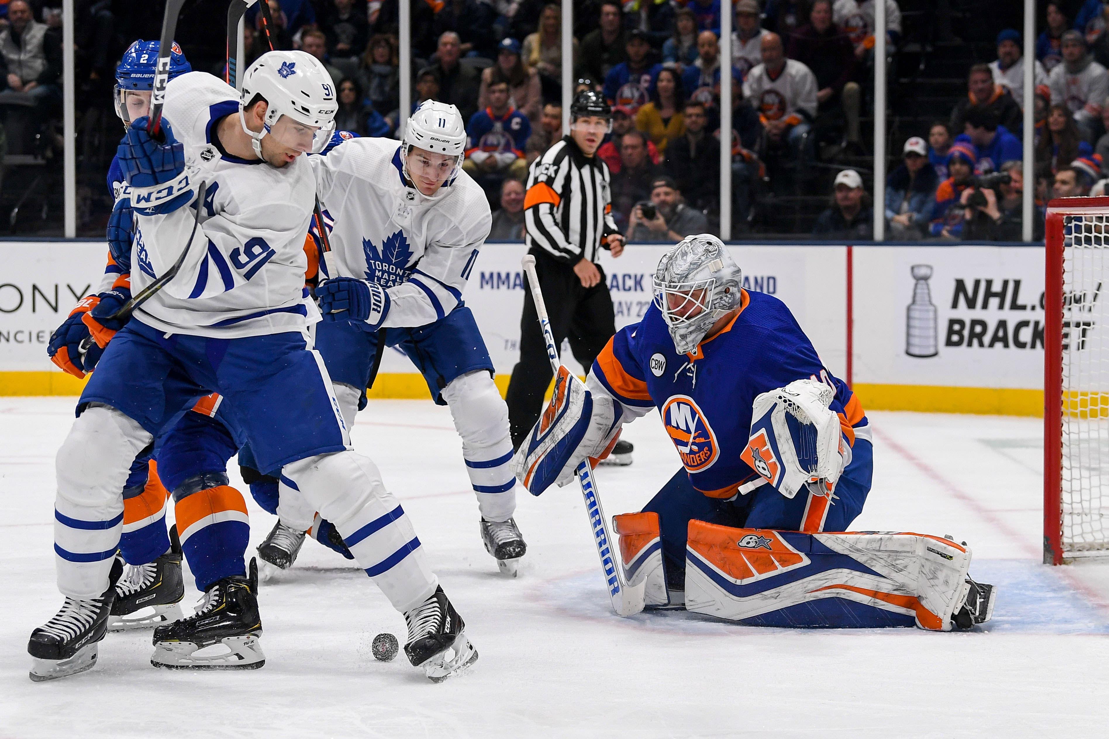 Apr 1, 2019; Uniondale, NY, USA; Toronto Maple Leafs center John Tavares (91) screens New York Islanders goaltender Robin Lehner (40) during the first period at Nassau Veterans Memorial Coliseum. Mandatory Credit: Dennis Schneidler-USA TODAY Sports / Dennis Schneidler