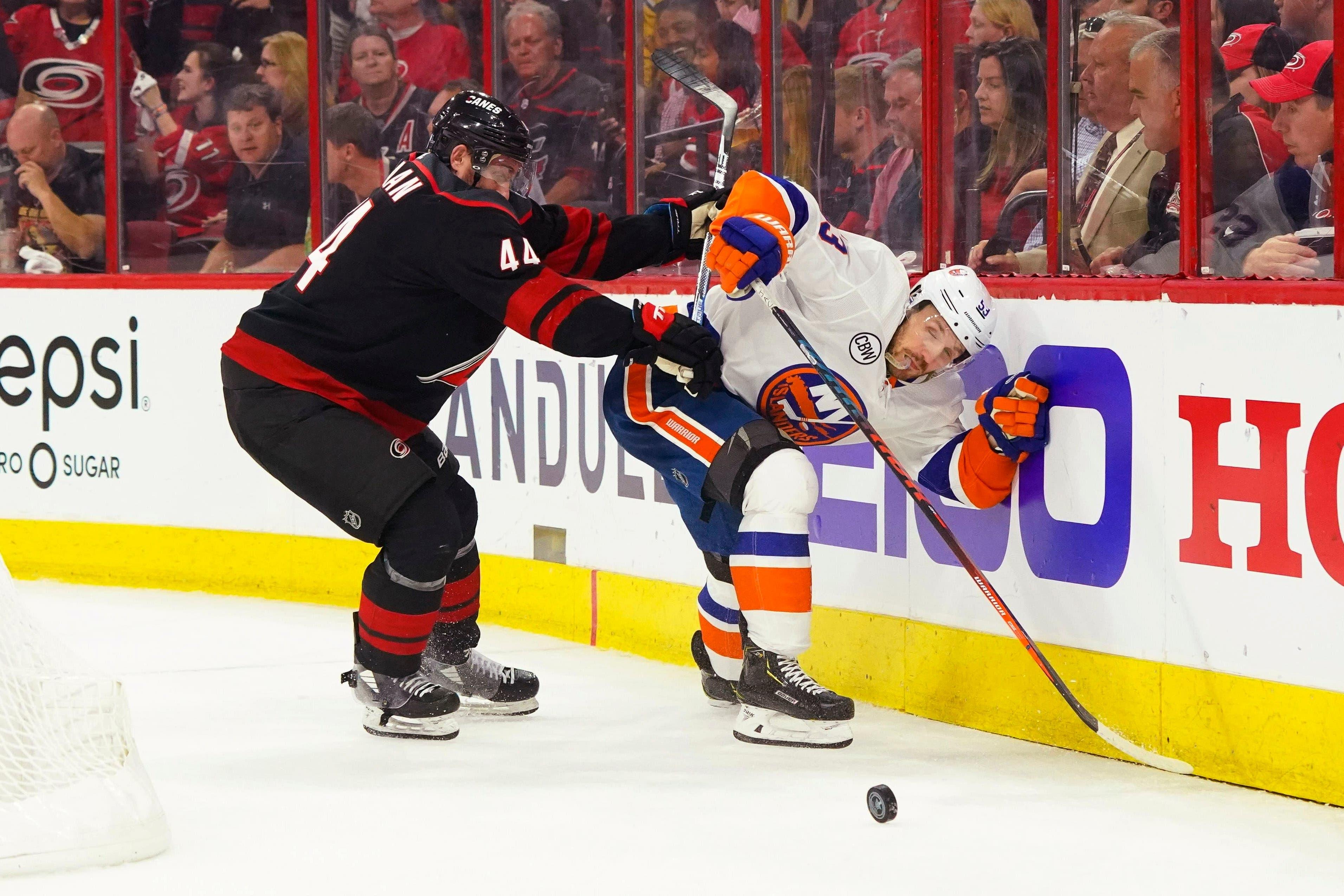 May 1, 2019; Raleigh, NC, USA; Carolina Hurricanes defenseman Calvin de Haan (44) battles for the puck with New York Islanders center Casey Cizikas (53) in game three of the second round of the 2019 Stanley Cup Playoffs at PNC Arena. Mandatory Credit: James Guillory-USA TODAY Sports / James Guillory