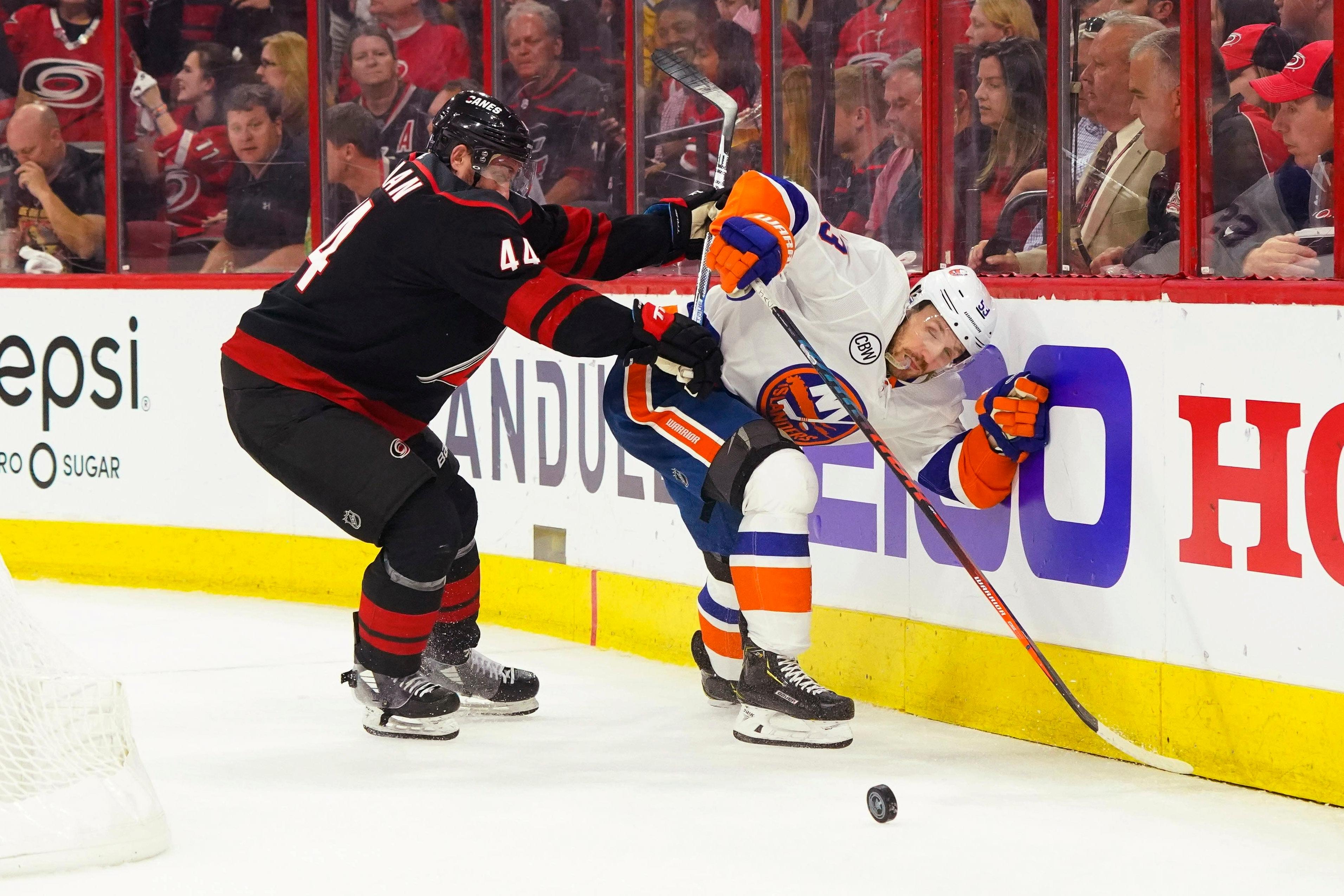 May 1, 2019; Raleigh, NC, USA; Carolina Hurricanes defenseman Calvin de Haan (44) battles for the puck with New York Islanders center Casey Cizikas (53) in game three of the second round of the 2019 Stanley Cup Playoffs at PNC Arena. Mandatory Credit: James Guillory-USA TODAY Sports 