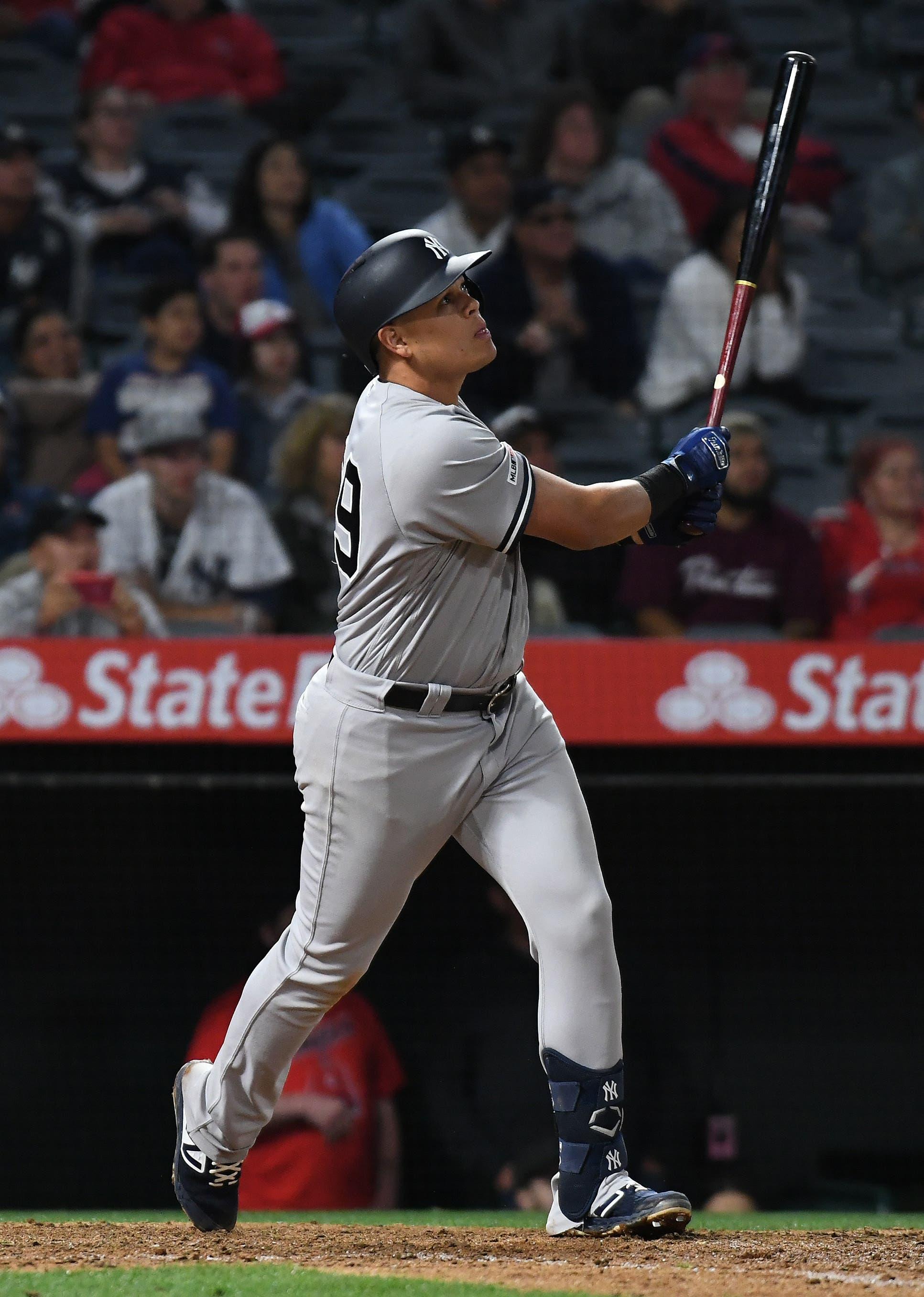 New York Yankees third baseman Gio Urshela hits a sacrifice fly against the Los Angeles Angels in the 12th inning at Angel Stadium of Anaheim. / Richard Mackson/USA TODAY Sports