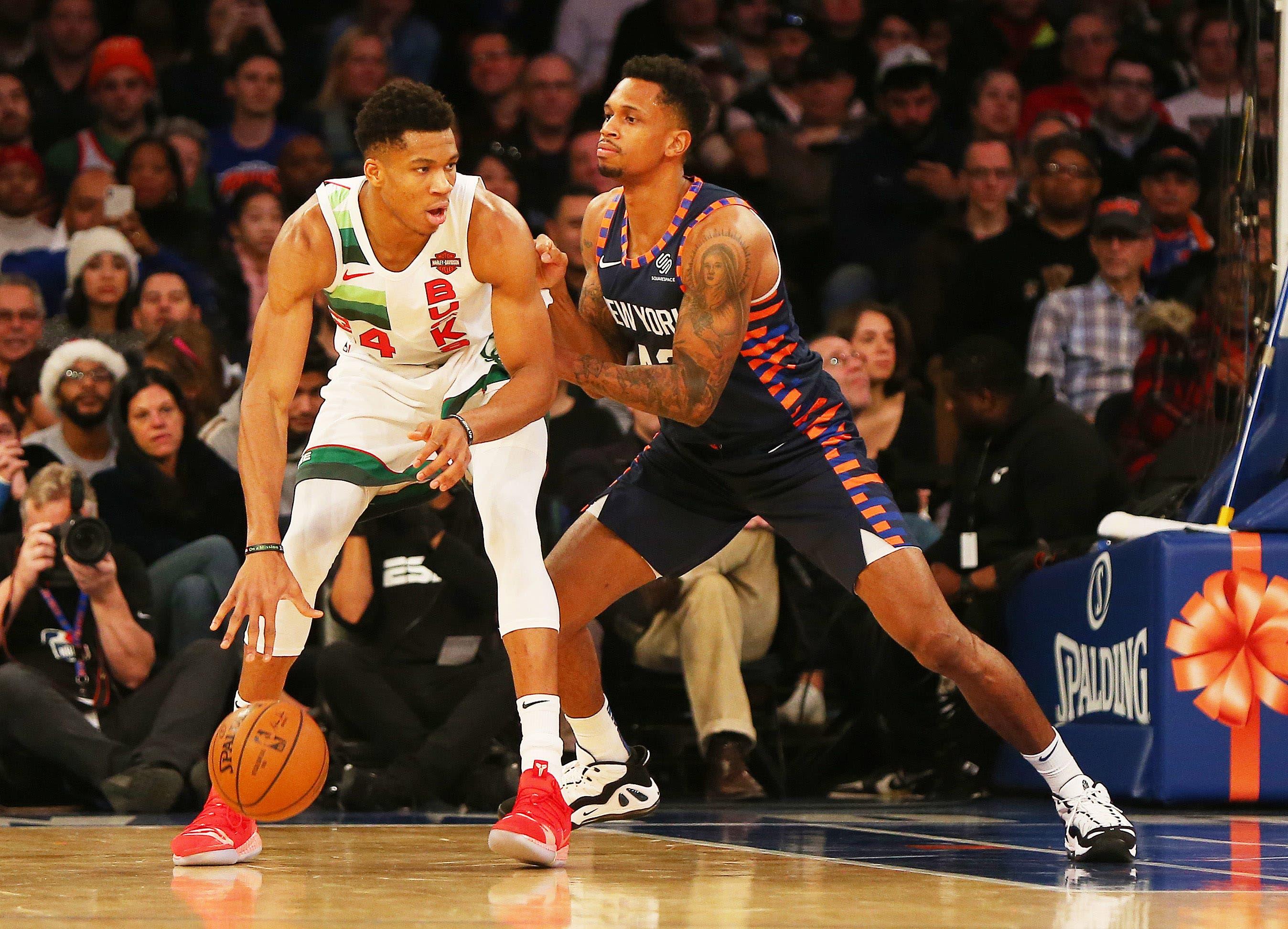 Dec 25, 2018; New York, NY, USA; Milwaukee Bucks forward Giannis Antetokounmpo (34) dribbles the ball while being defended by New York Knicks forward Lance Thomas (42) during the first half at Madison Square Garden. Mandatory Credit: Andy Marlin-USA TODAY Sports / Andy Marlin