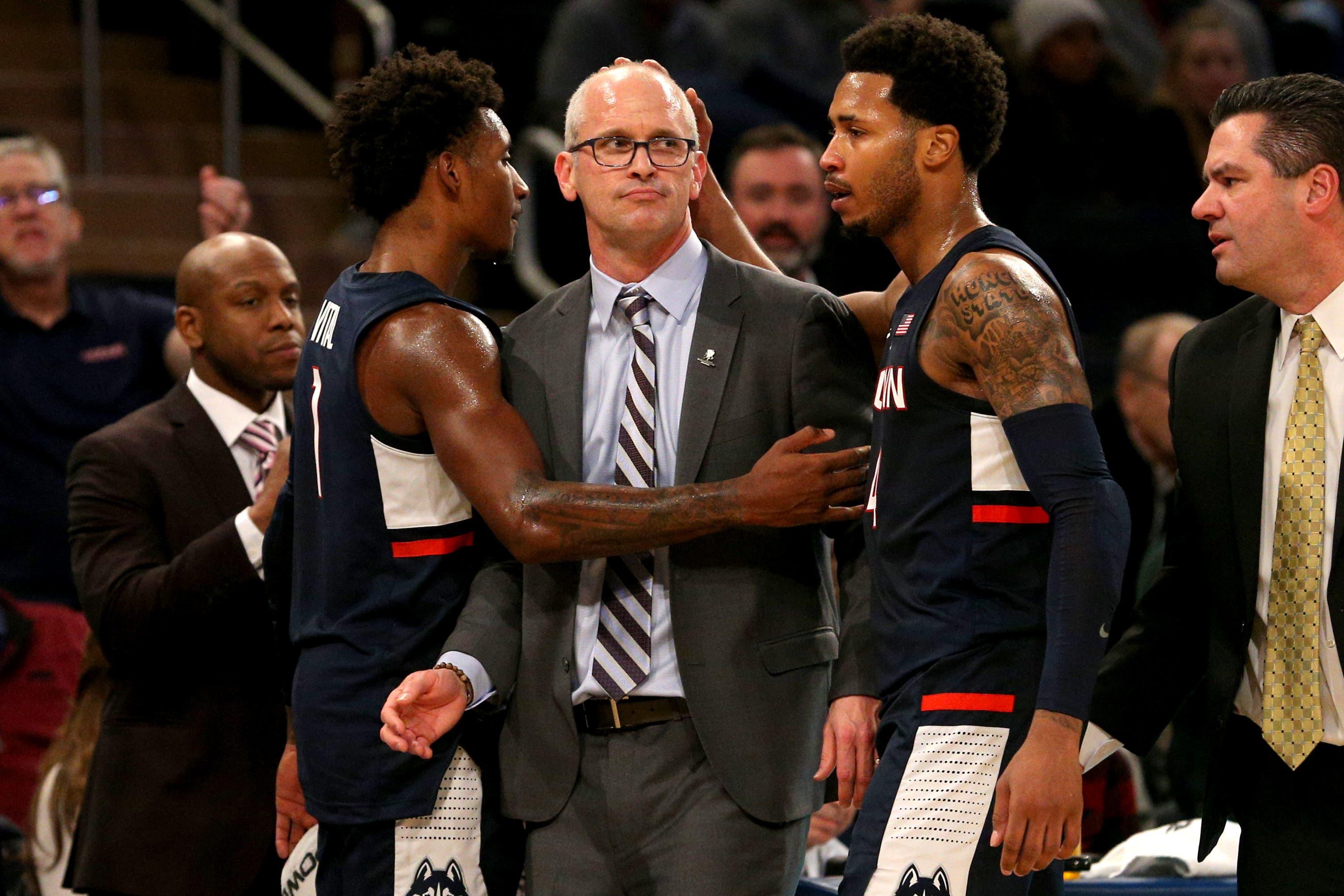 Nov 16, 2018; New York, NY, USA; Connecticut Huskies head coach Dan Hurley is embraced by guard Christian Vital (1) and guard Jalen Adams (4) after being ejected from a game against the Iowa Hawkeyes during the second half at Madison Square Garden. Mandatory Credit: Brad Penner-USA TODAY Sports / Brad Penner