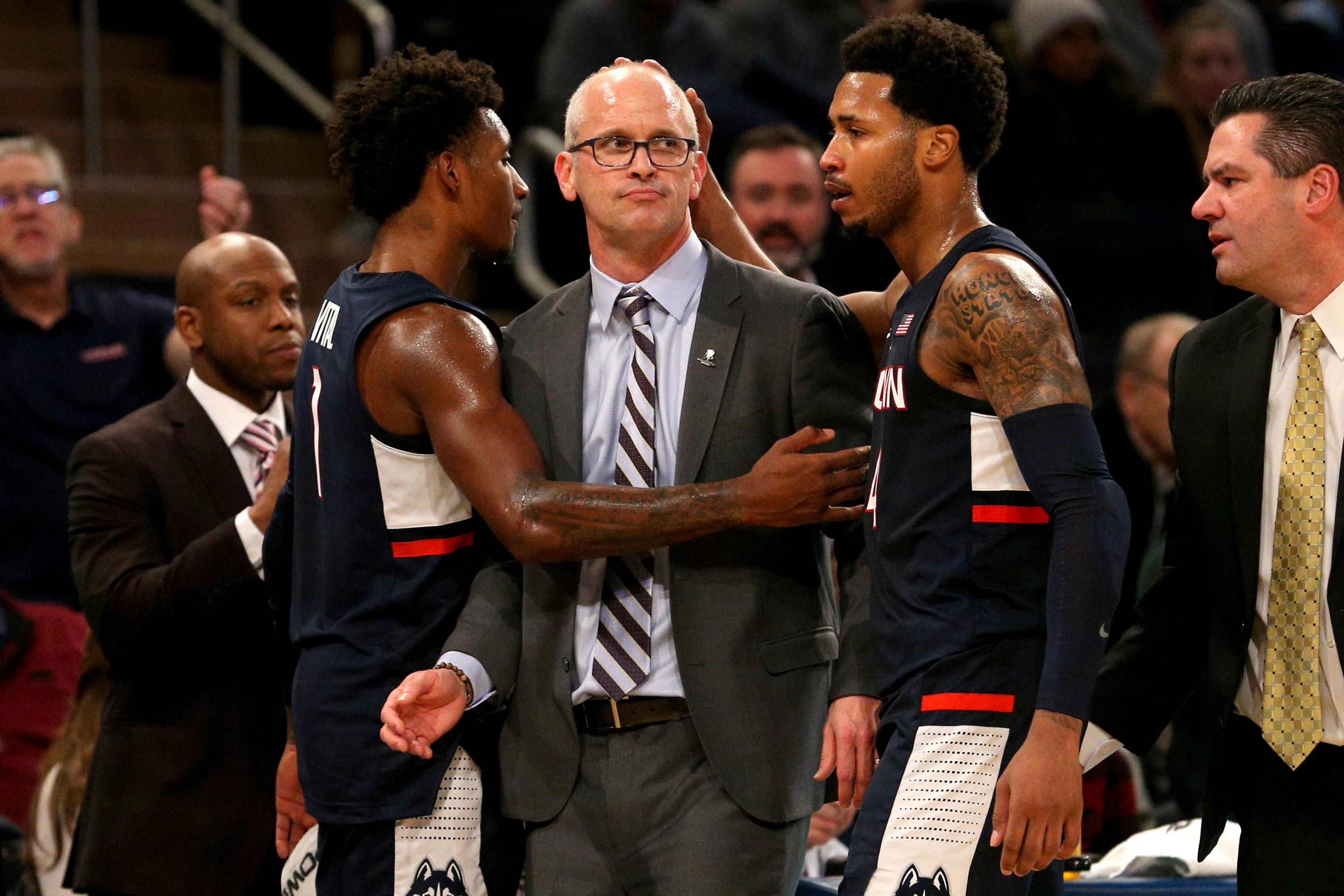 Nov 16, 2018; New York, NY, USA; Connecticut Huskies head coach Dan Hurley is embraced by guard Christian Vital (1) and guard Jalen Adams (4) after being ejected from a game against the Iowa Hawkeyes during the second half at Madison Square Garden. Mandatory Credit: Brad Penner-USA TODAY Sports