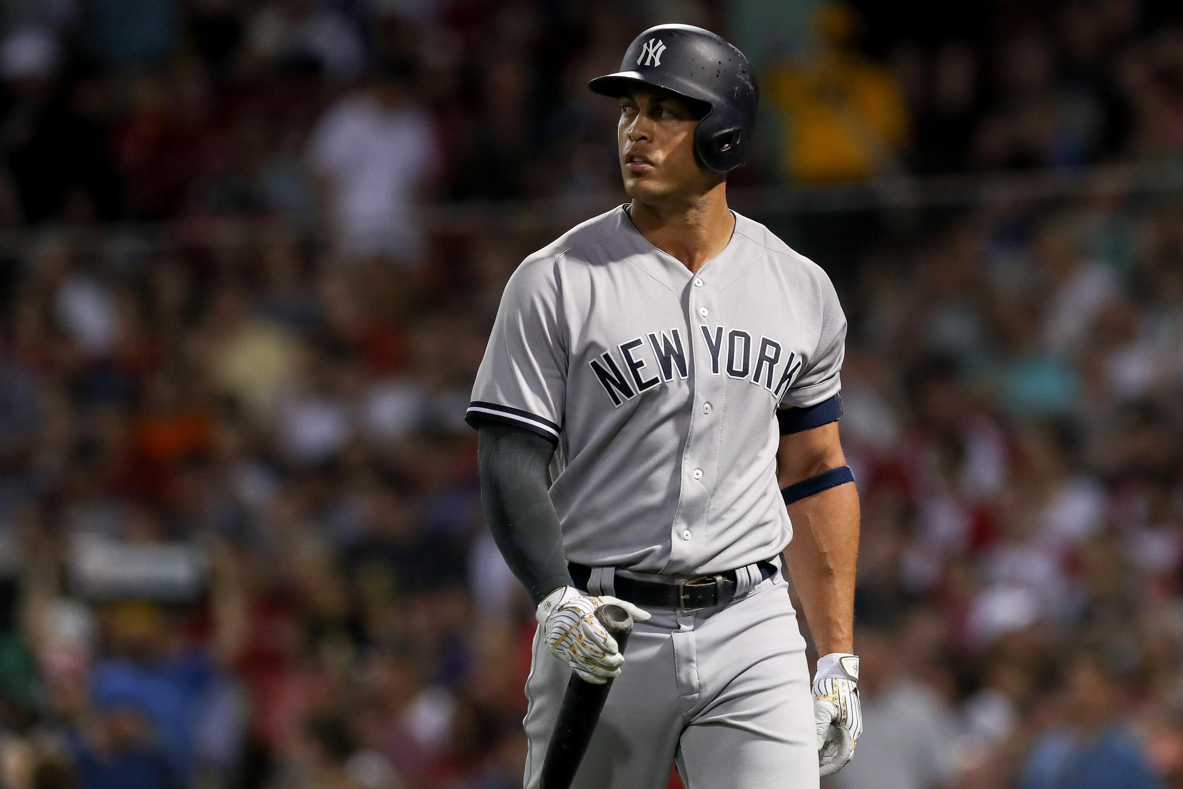 Aug 2, 2018; Boston, MA, USA; New York Yankees left fielder Giancarlo Stanton (27) walks back to the dugout after striking out against the Boston Red Sox at Fenway Park. Mandatory Credit: Paul Rutherford-USA TODAY Sports / Paul Rutherford