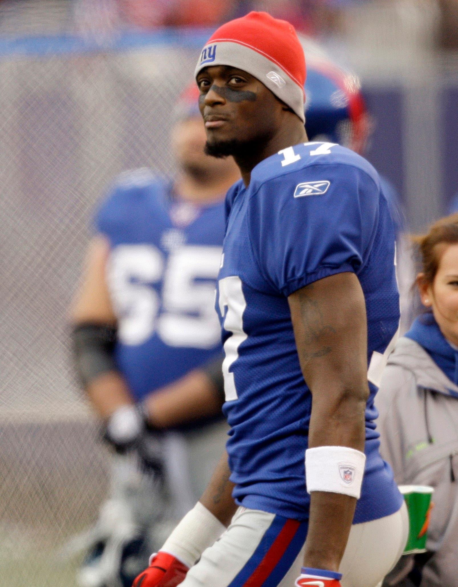 ** FILE ** In this Nov. 16, 2008 file photo, New York Giants wide receiver Plaxico Burress (17) watches from the sidelines against the Baltimore Ravens during the first half of an NFL football game in East Rutherford, N.J.   The New York Giants released Super Bowl hero Plaxico Burress on Friday, April 3, 2009, a little more than four months after the talented but troubled wide receiver accidentally shot himself in the thigh in a New York City nightclub.  (AP Photo/Rob Carr, File)undefined