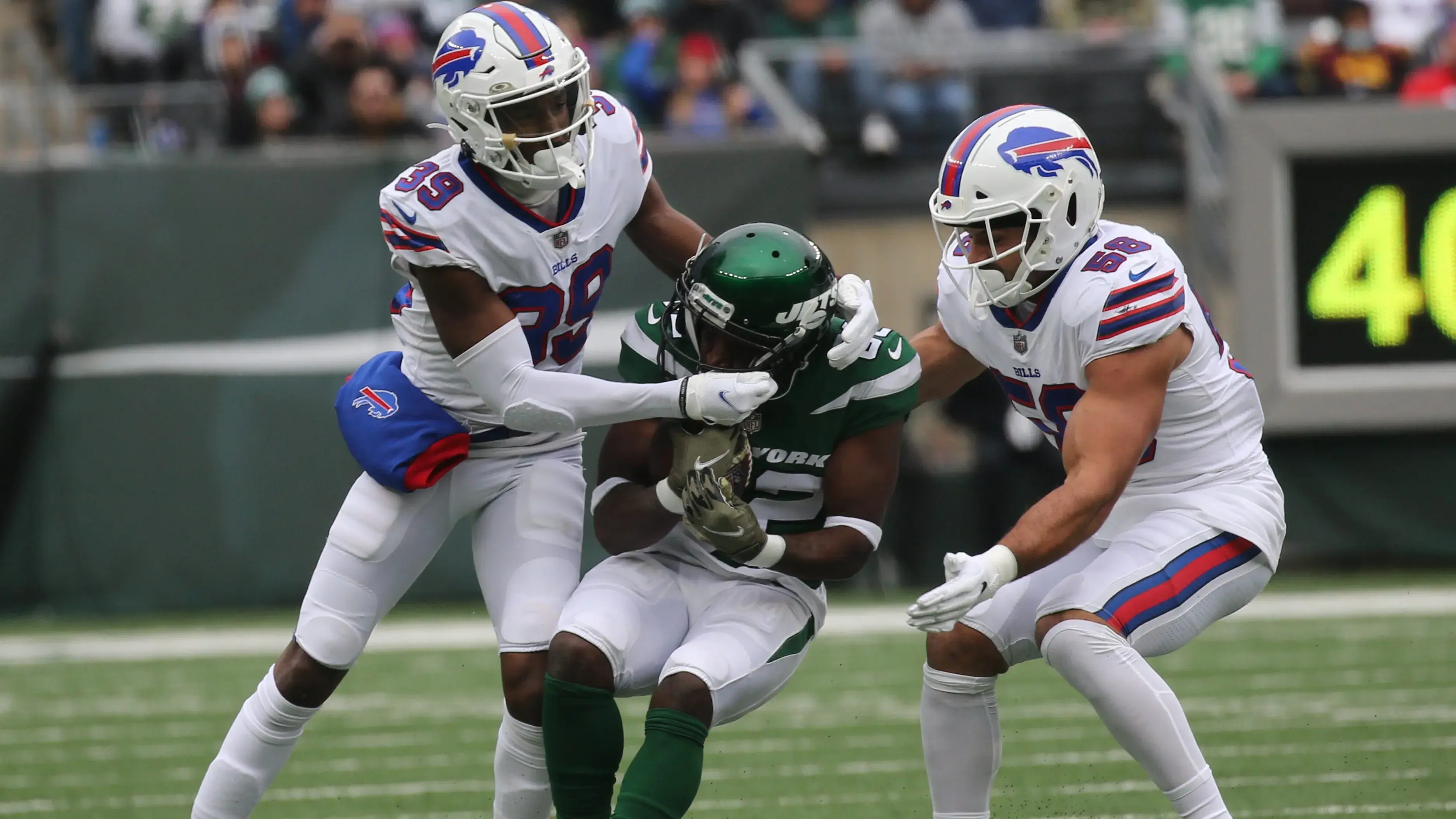 Levi Wallace and Matt Milano of the Buffalo Bills tackle Michael Carter of the Jets after he made a reception in the first quarter. The Buffalo Bills play the New York Jets at Metlife Stadium in East Rutherford, NJ on November 14, 2021. The Buffalo Bills Play The New York Jets At Metlife Stadium In East Rutherford Nj On November 14 2021 / Chris Pedota, NorthJersey.com / USA TODAY NETWORK