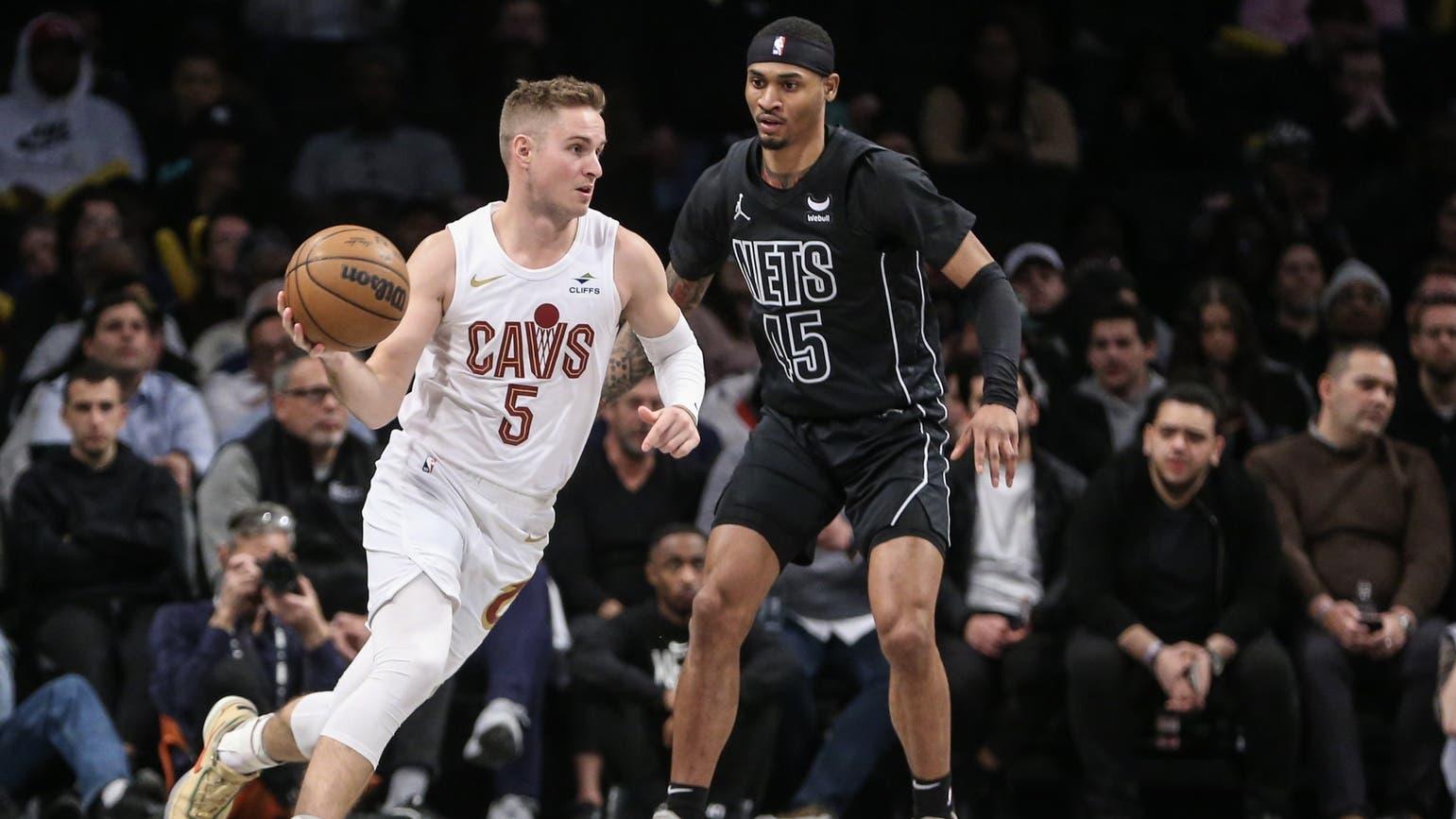 Feb 8, 2024; Brooklyn, New York, USA; Cleveland Cavaliers guard Sam Merrill (5) looks to drive past Brooklyn Nets guard Keon Johnson (45) in the fourth quarter at Barclays Center. / Wendell Cruz-USA TODAY Sports