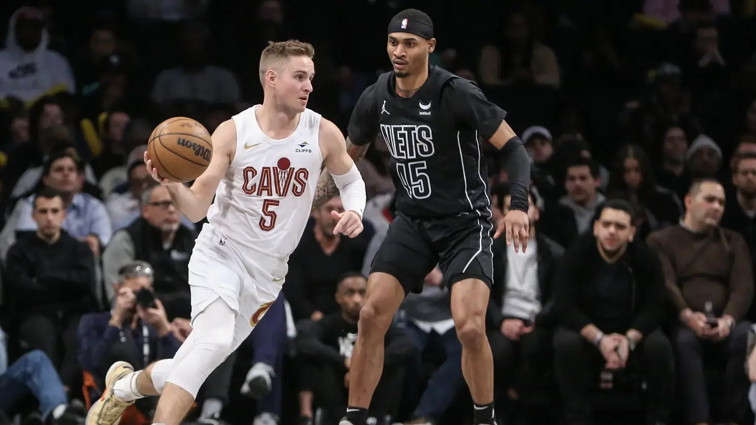 Feb 8, 2024; Brooklyn, New York, USA; Cleveland Cavaliers guard Sam Merrill (5) looks to drive past Brooklyn Nets guard Keon Johnson (45) in the fourth quarter at Barclays Center.