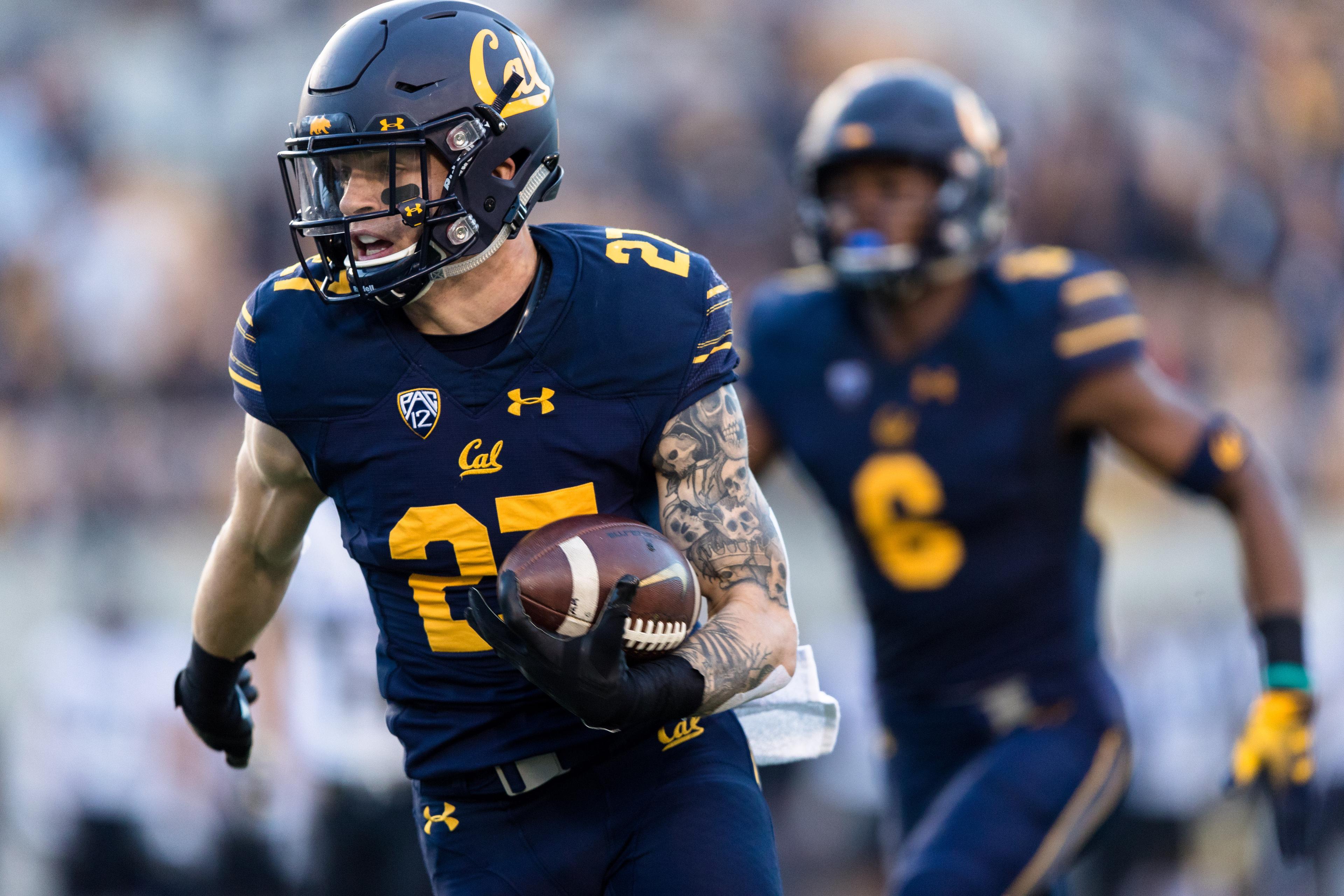 Nov 24, 2018; Berkeley, CA, USA; California Golden Bears safety Ashtyn Davis (27) runs the ball for an interception return and touchdown against the Colorado Buffaloes in the first quarter at California Memorial Stadium. Mandatory Credit: John Hefti-USA TODAY Sports