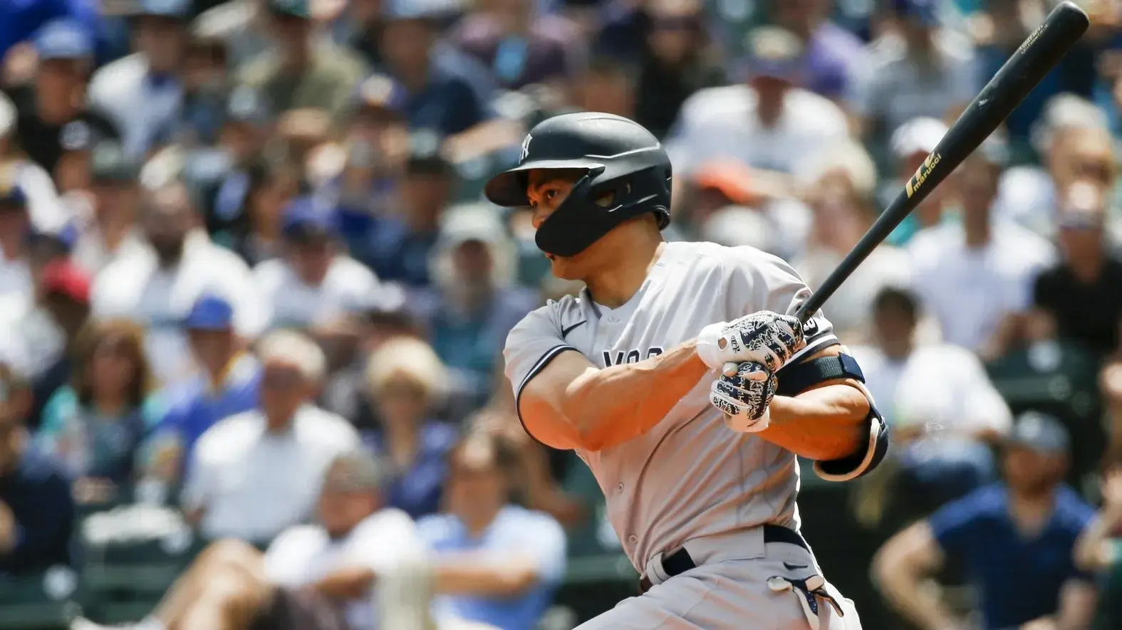 Jul 8, 2021; Seattle, Washington, USA; New York Yankees designated hitter Giancarlo Stanton (27) hits a single against the Seattle Mariners during the second inning at T-Mobile Park. / Joe Nicholson-USA TODAY Sports