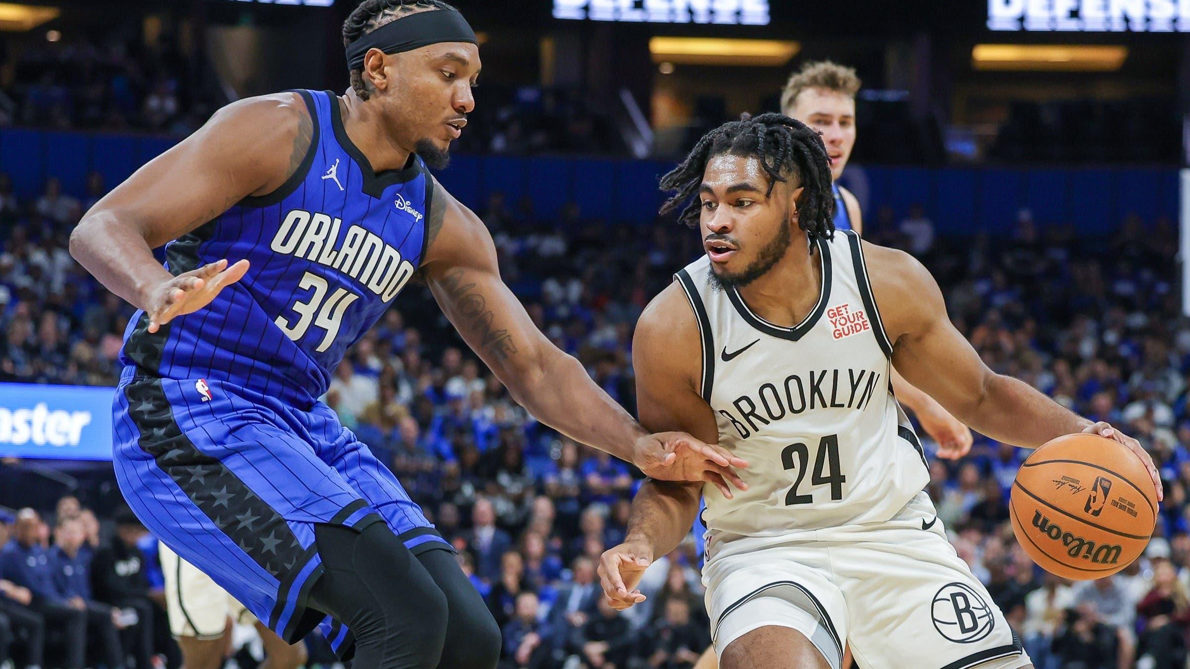 Oct 25, 2024; Orlando, Florida, USA; Orlando Magic center Wendell Carter Jr. (34) defends Brooklyn Nets guard Cam Thomas (24) during the second quarter at Kia Center.