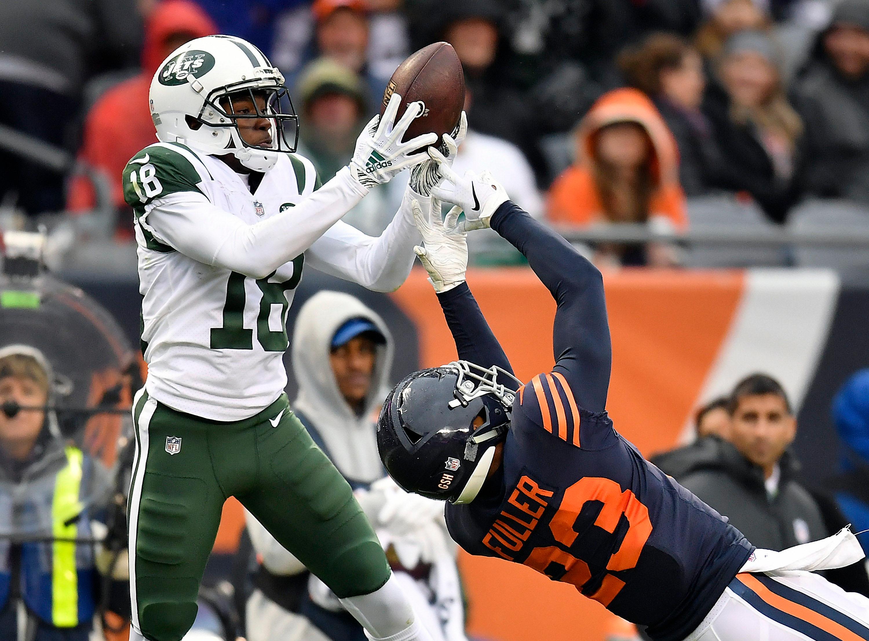 New York Jets wide receiver Deontay Burnett catches the ball against Chicago Bears cornerback Kyle Fuller at Soldier Field.