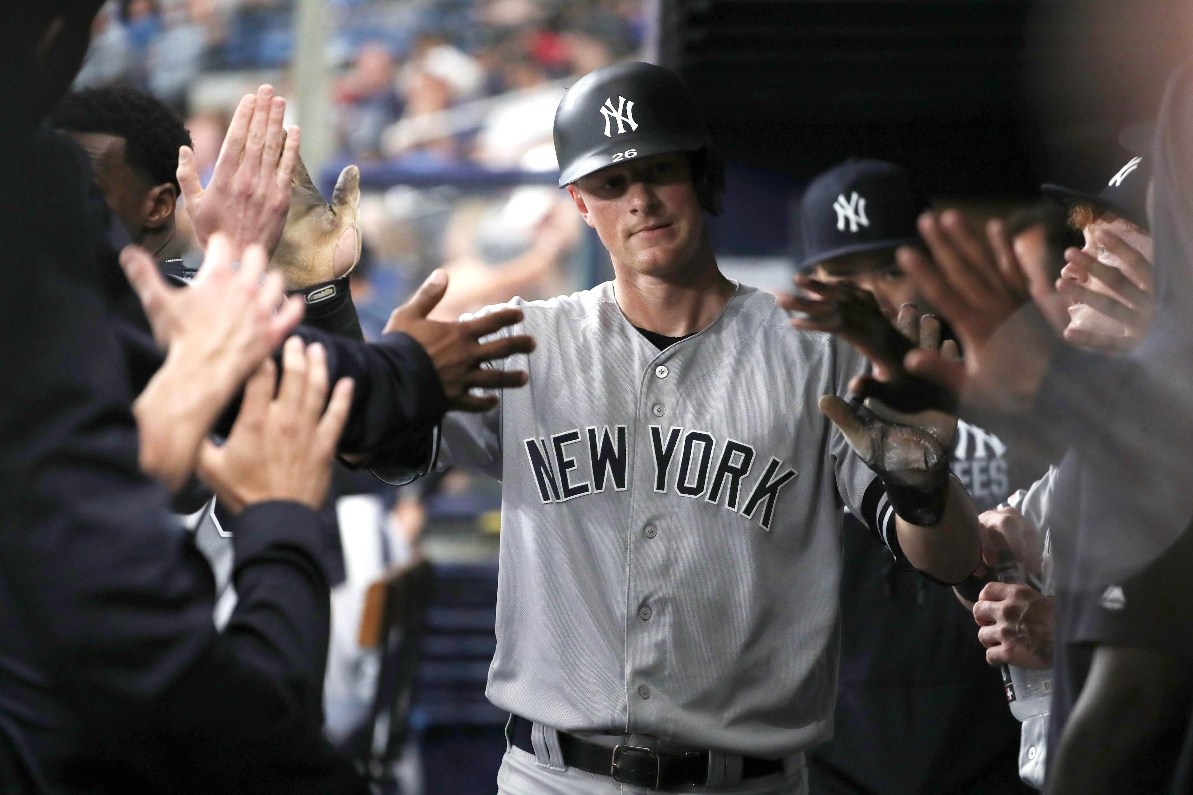 New York Yankees second baseman DJ LeMahieu is congratulated in the dugout as he scores a run during the first inning against the Tampa Bay Rays at Tropicana Field. / Kim Klement/USA TODAY Sports