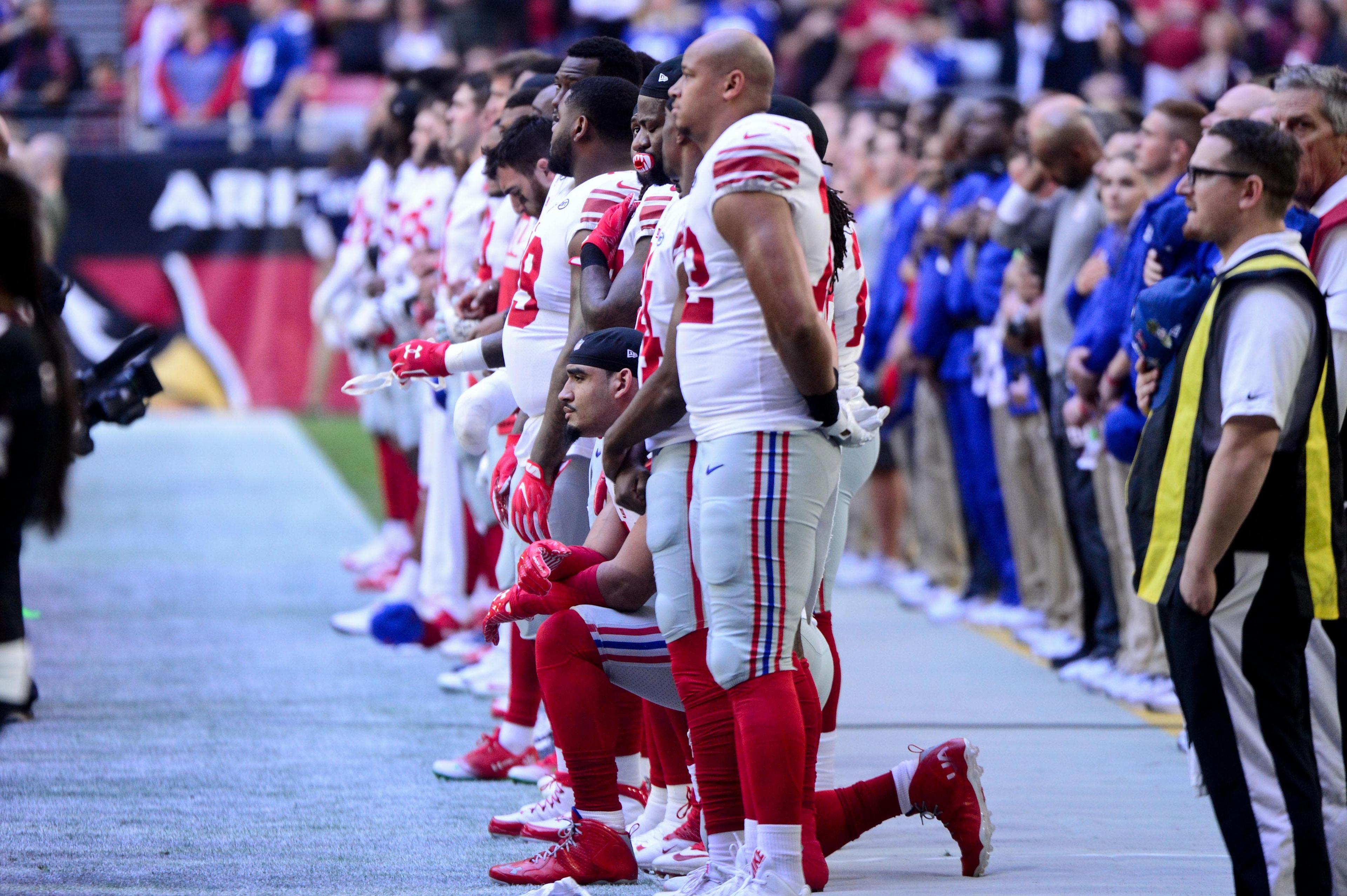 Dec 24, 2017; Glendale, AZ, USA; New York Giants defensive end Olivier Vernon (54) kneels during the National Anthem prior to the game against the Arizona Cardinals at University of Phoenix Stadium. Mandatory Credit: Matt Kartozian-USA TODAY Sports / Matt Kartozian