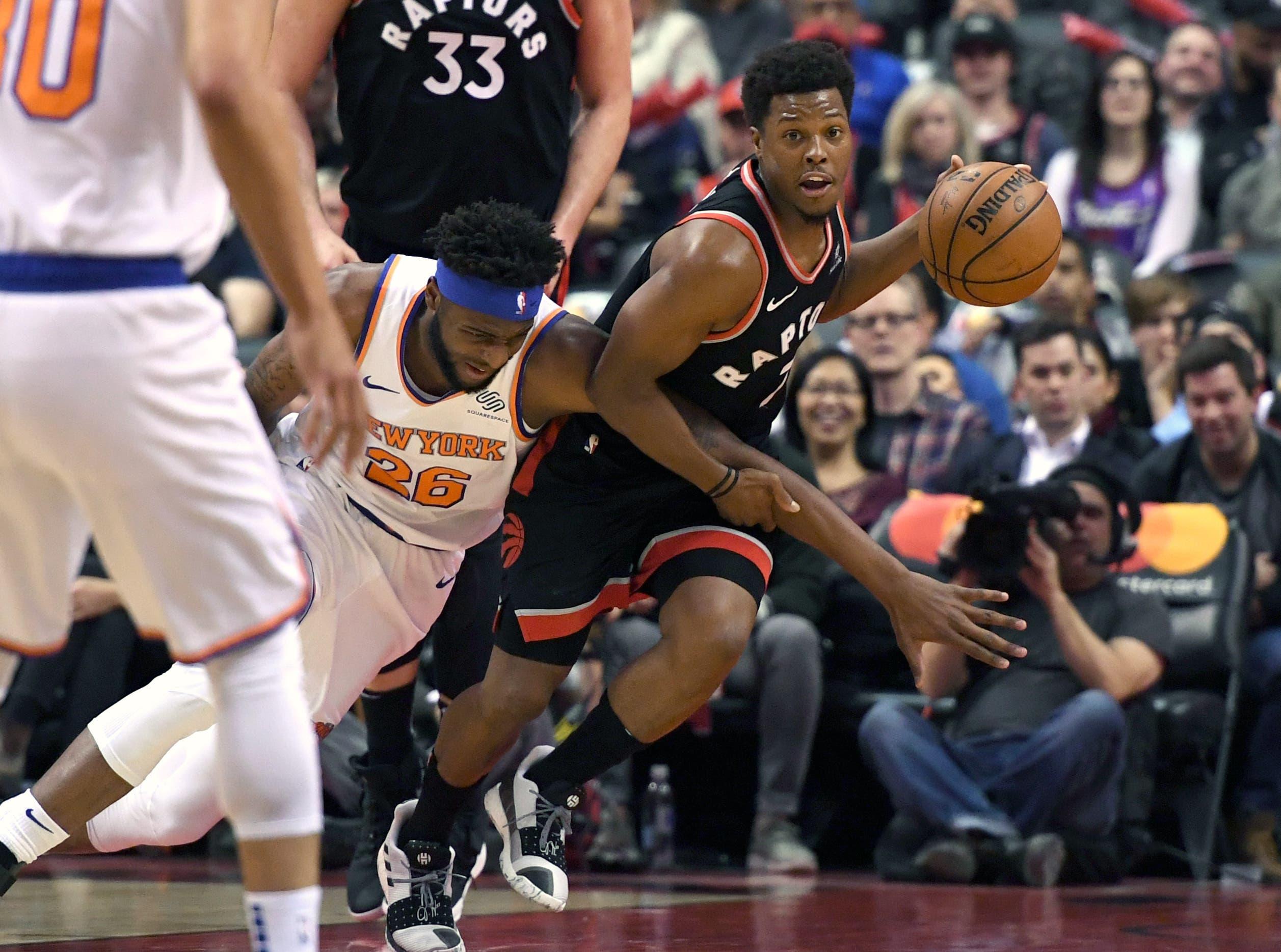 Mar 18, 2019; Toronto, Ontario, CAN; Toronto Raptors guard Kyle Lowry (7) battles for a loose ball with New York Knicks center Mitchell Robinson (26) in the second half at Scotiabank Arena. Mandatory Credit: Dan Hamilton-USA TODAY Sports / Dan Hamilton