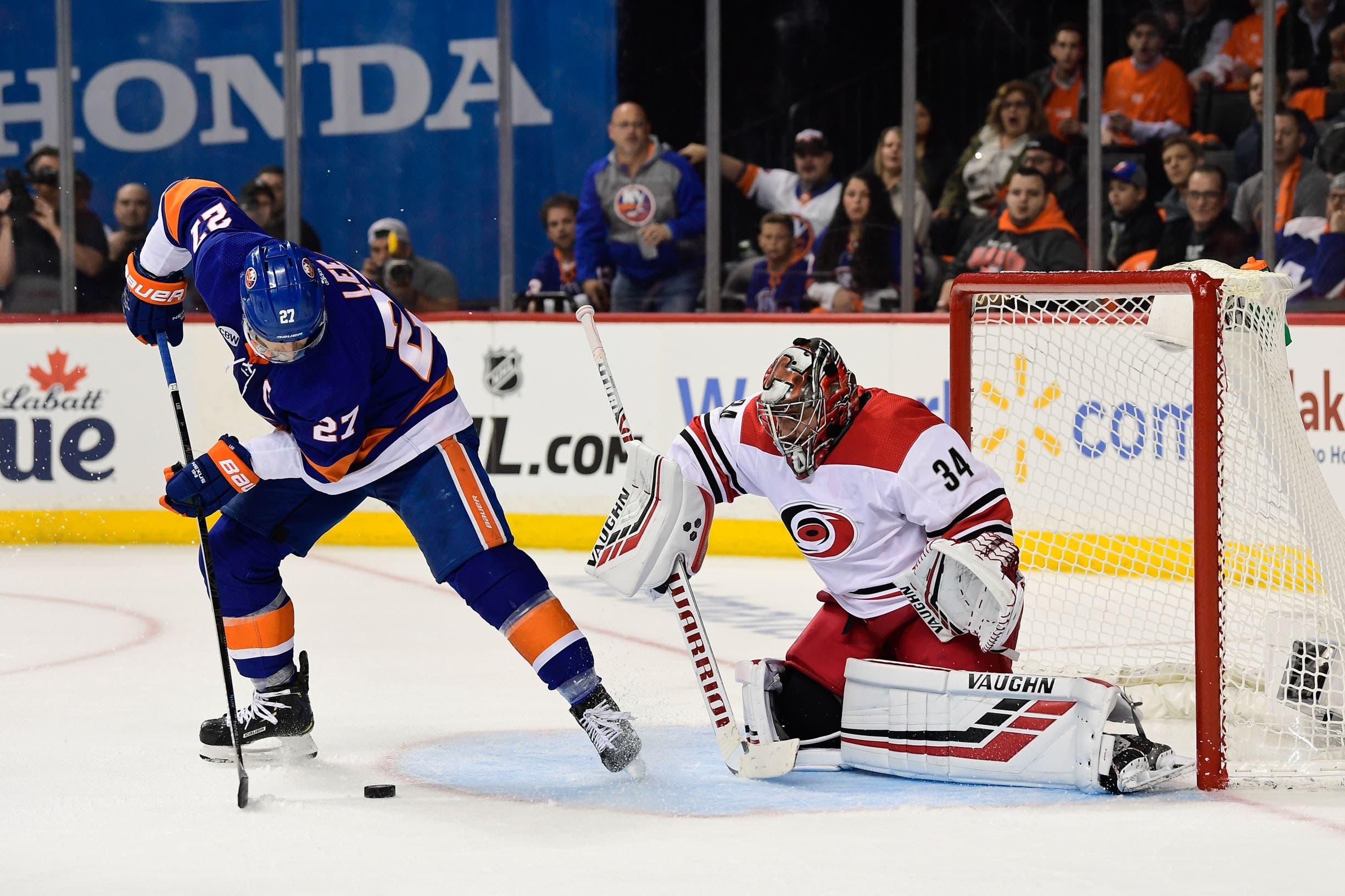 New York Islanders left wing Anders Lee handles the puck against Carolina Hurricanes goalie Petr Mrazek during the second period in Game 1 of the second round of the 2019 Stanley Cup Playoffs at Barclays Center. / Catalina Fragoso/USA TODAY Sports