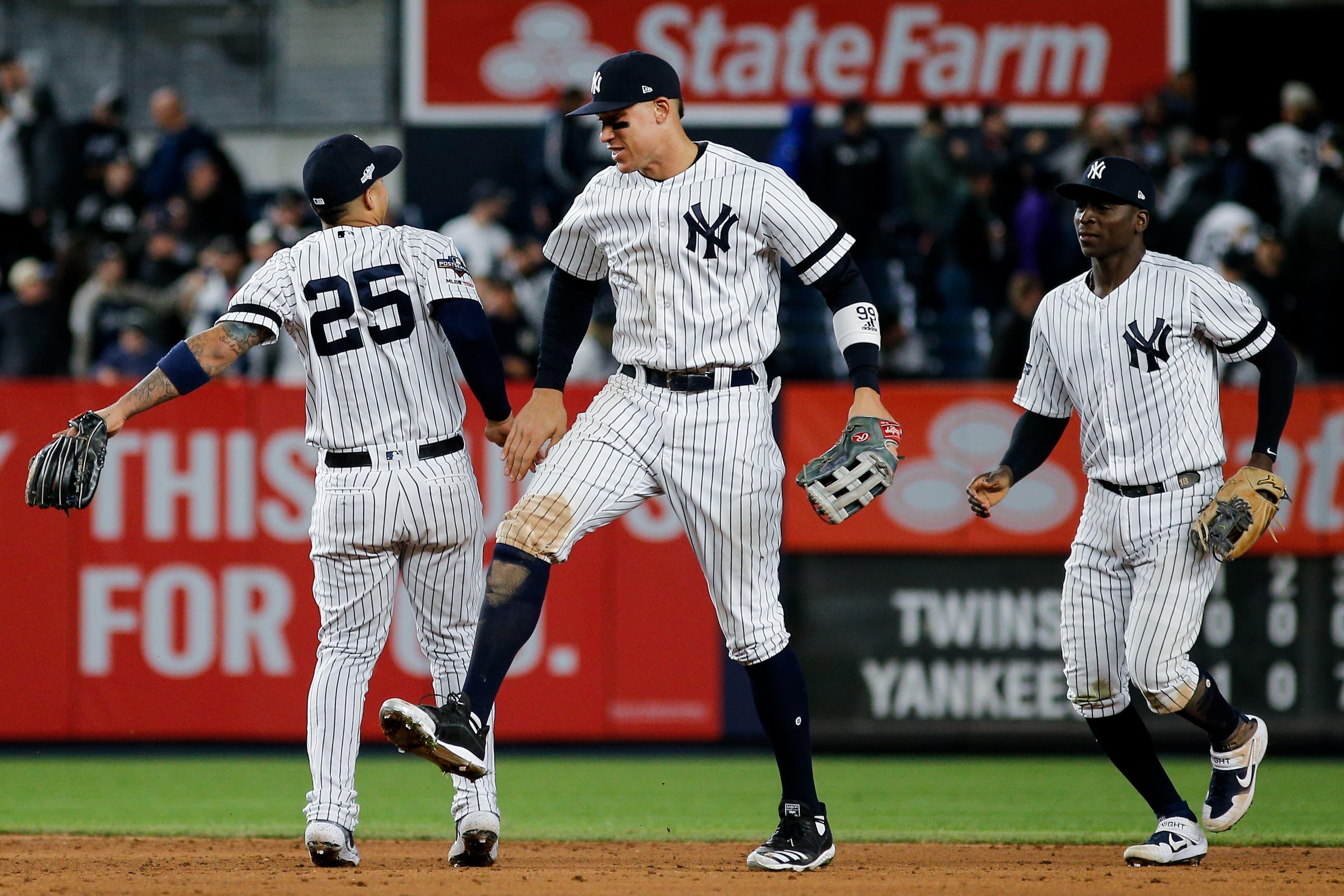 Oct 5, 2019; Bronx, NY, USA; New York Yankees second baseman Gleyber Torres (25), right fielder Aaron Judge (middle), and shortstop Didi Gregorius (right) celebrate defeating the Minnesota Twins in game two of the 2019 ALDS playoff baseball series at Yankee Stadium. Mandatory Credit: Andy Marlin-USA TODAY Sports / Andy Marlin