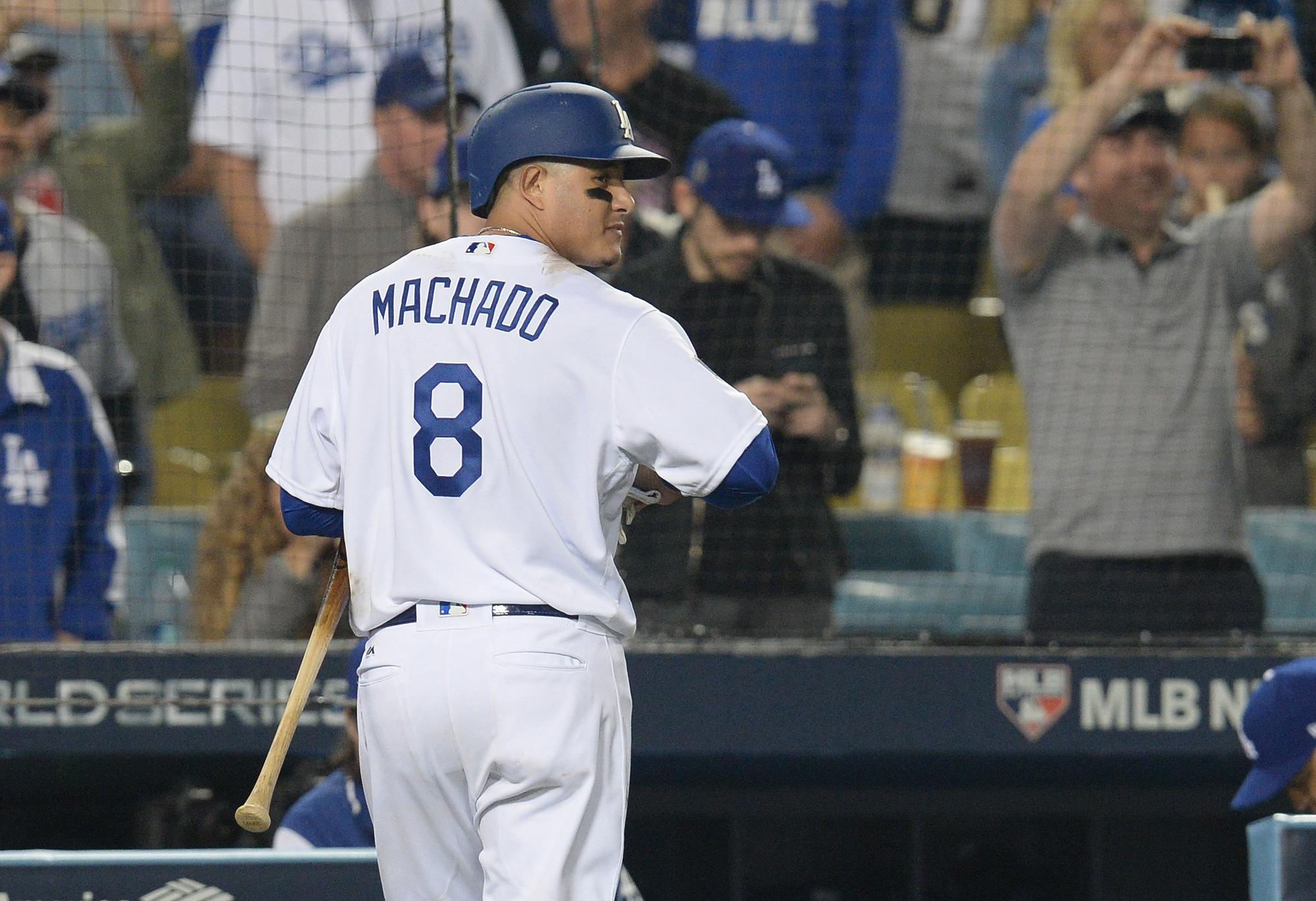 Oct 28, 2018; Los Angeles, CA, USA; Los Angeles Dodgers shortstop Manny Machado (8) walks back to the dugout after striking out to the game against the Boston Red Sox in game five of the 2018 World Series at Dodger Stadium. The Boston Red Sox defeated the Los Angeles Dodgers 5-1. Mandatory Credit: Gary A. Vasquez-USA TODAY Sports