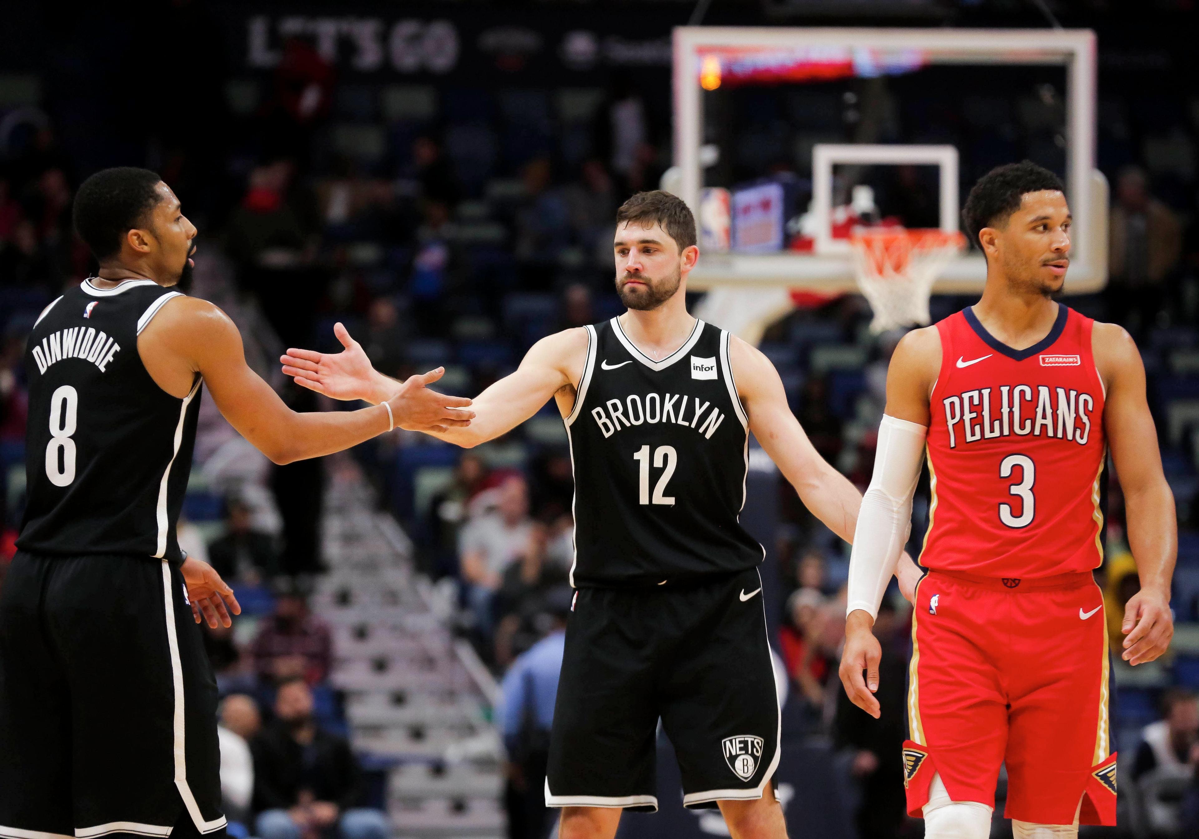 Dec 17, 2019; New Orleans, LA, USA; Brooklyn Nets guard Joe Harris (12) celebrates with guard Spencer Dinwiddie (8) during overtime as New Orleans Pelicans guard Josh Hart (3) looks on at the Smoothie King Center. Mandatory Credit: Derick E. Hingle-USA TODAY Sports / Derick E. Hingle