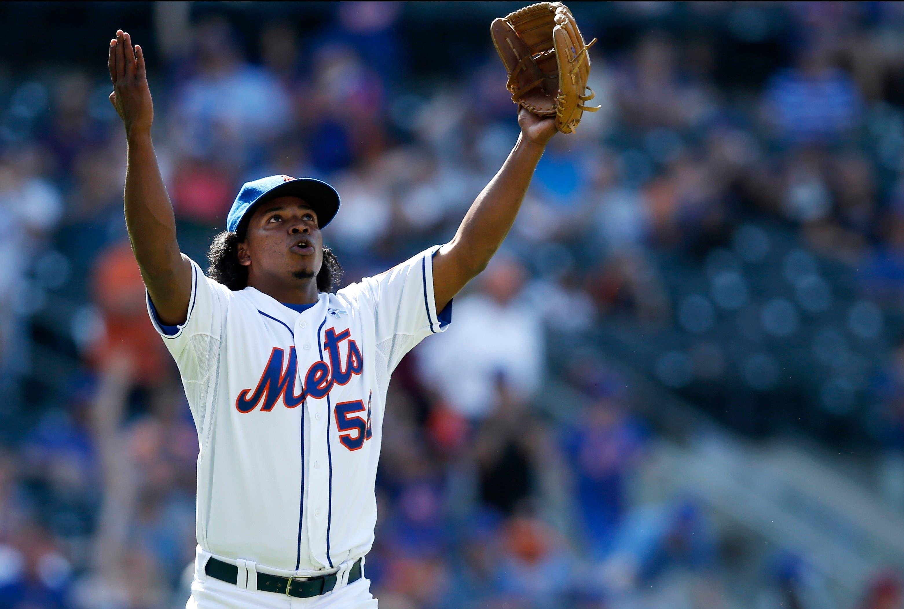 Jenrry Mejia celebrates after earning his seventh save of the season as the Mets defeated the Padres, 3-1. He did not allow a baserunner in two innings of work. / AP