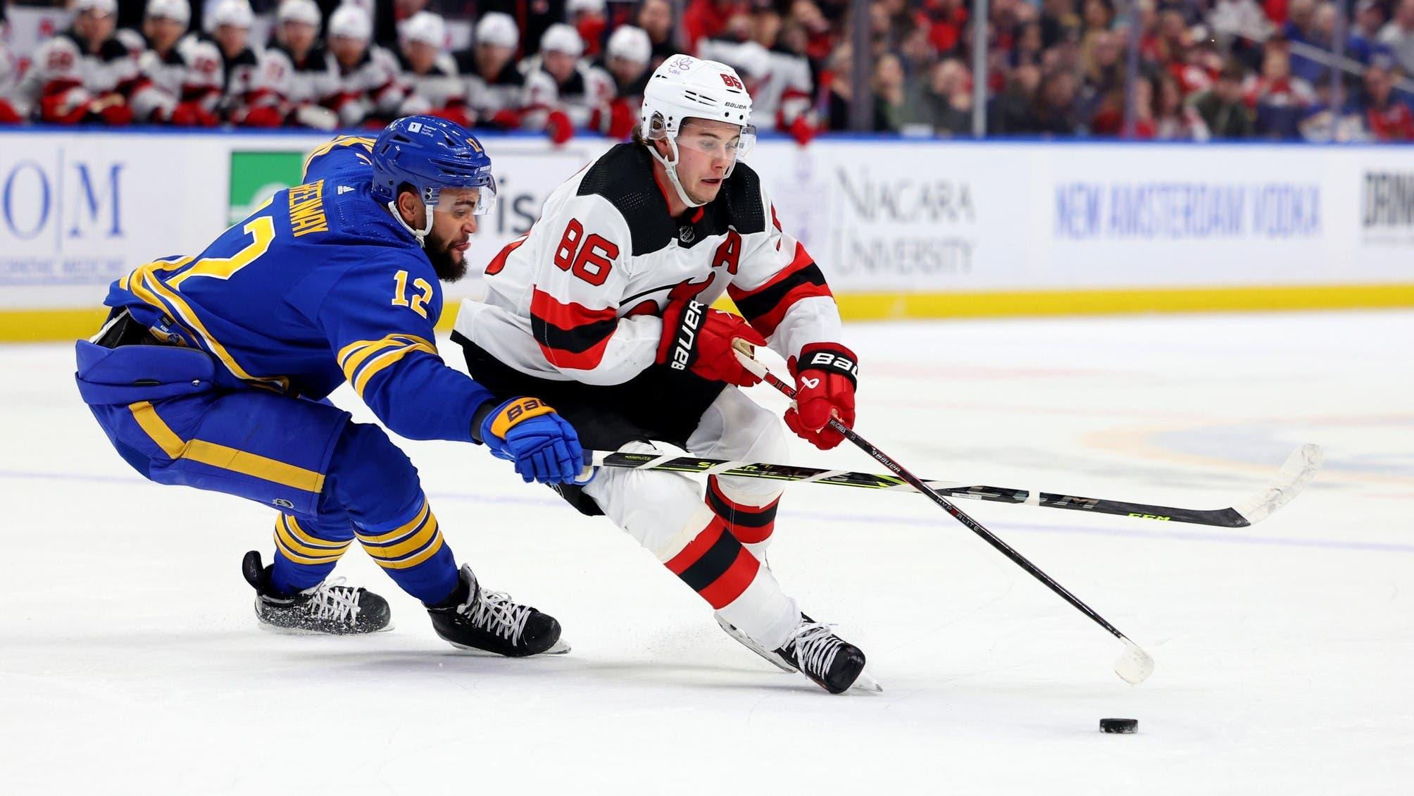 Mar 29, 2024; Buffalo, New York, USA; New Jersey Devils center Jack Hughes (86) carries the puck as Buffalo Sabres left wing Jordan Greenway (12) tries to defend during the first period at KeyBank Center. / Timothy T. Ludwig-Imagn Images