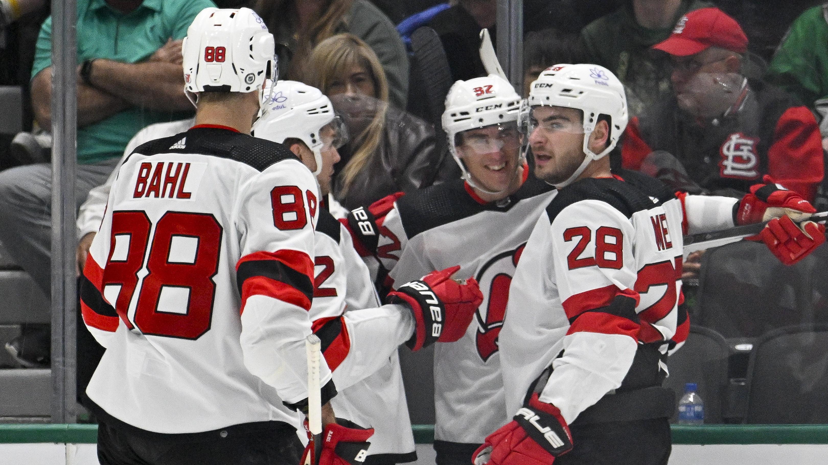 New Jersey Devils defenseman Kevin Bahl (88) and center Curtis Lazar (42) and right wing Timo Meier (28) celebrates a goal scored by Meier against the Dallas Stars during the second period at the American Airlines Center / Jerome Miron - USA TODAY Sports