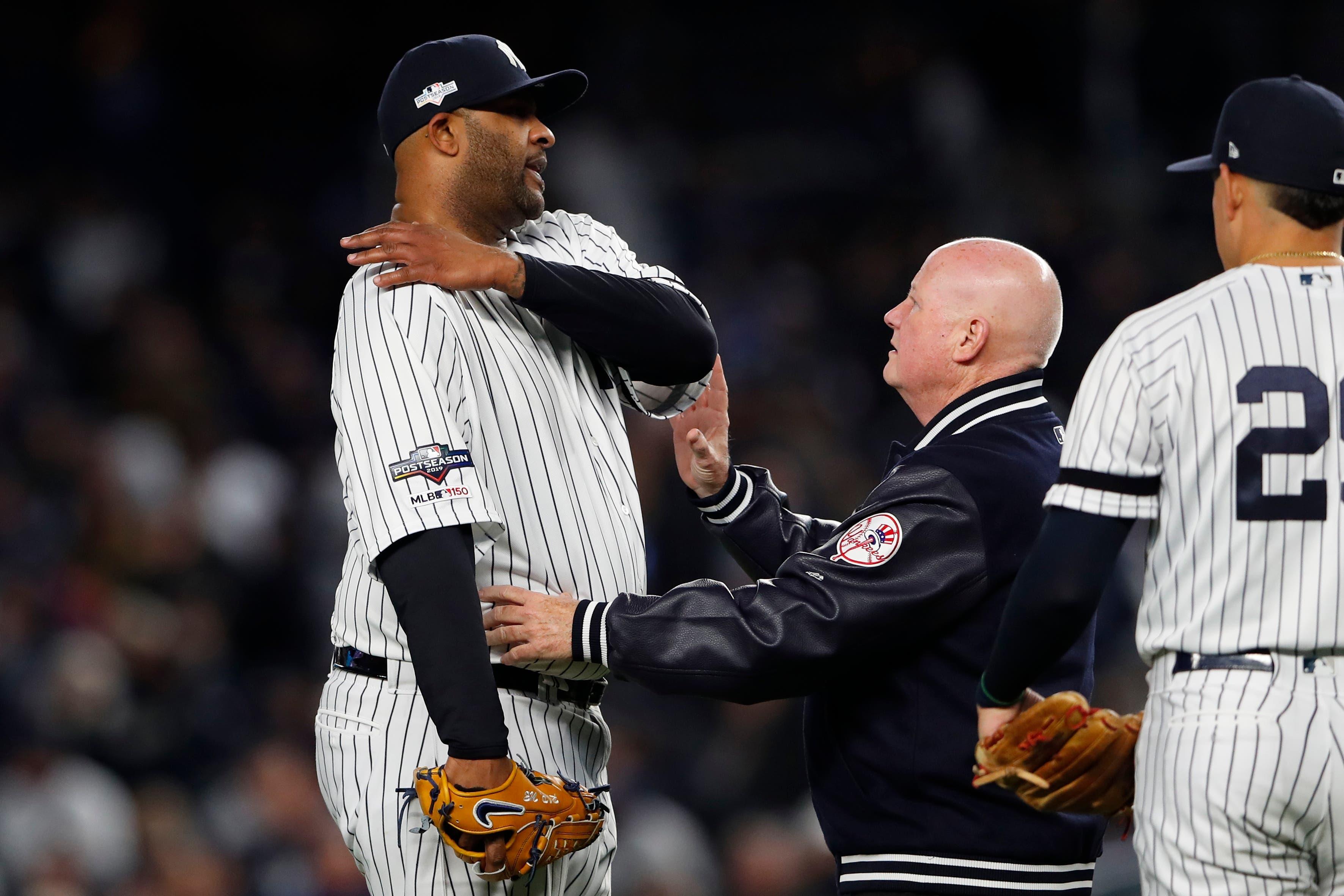 Oct 17, 2019; Bronx, NY, USA; New York Yankees pitcher CC Sabathia (52) reacts as he examined by trainer Steve Donohue after suffering an apparent injury against the Houston Astros during the eighth inning of game four of the 2019 ALCS playoff baseball series at Yankee Stadium. Mandatory Credit: Noah K. Murray-USA TODAY Sports / Noah K. Murray