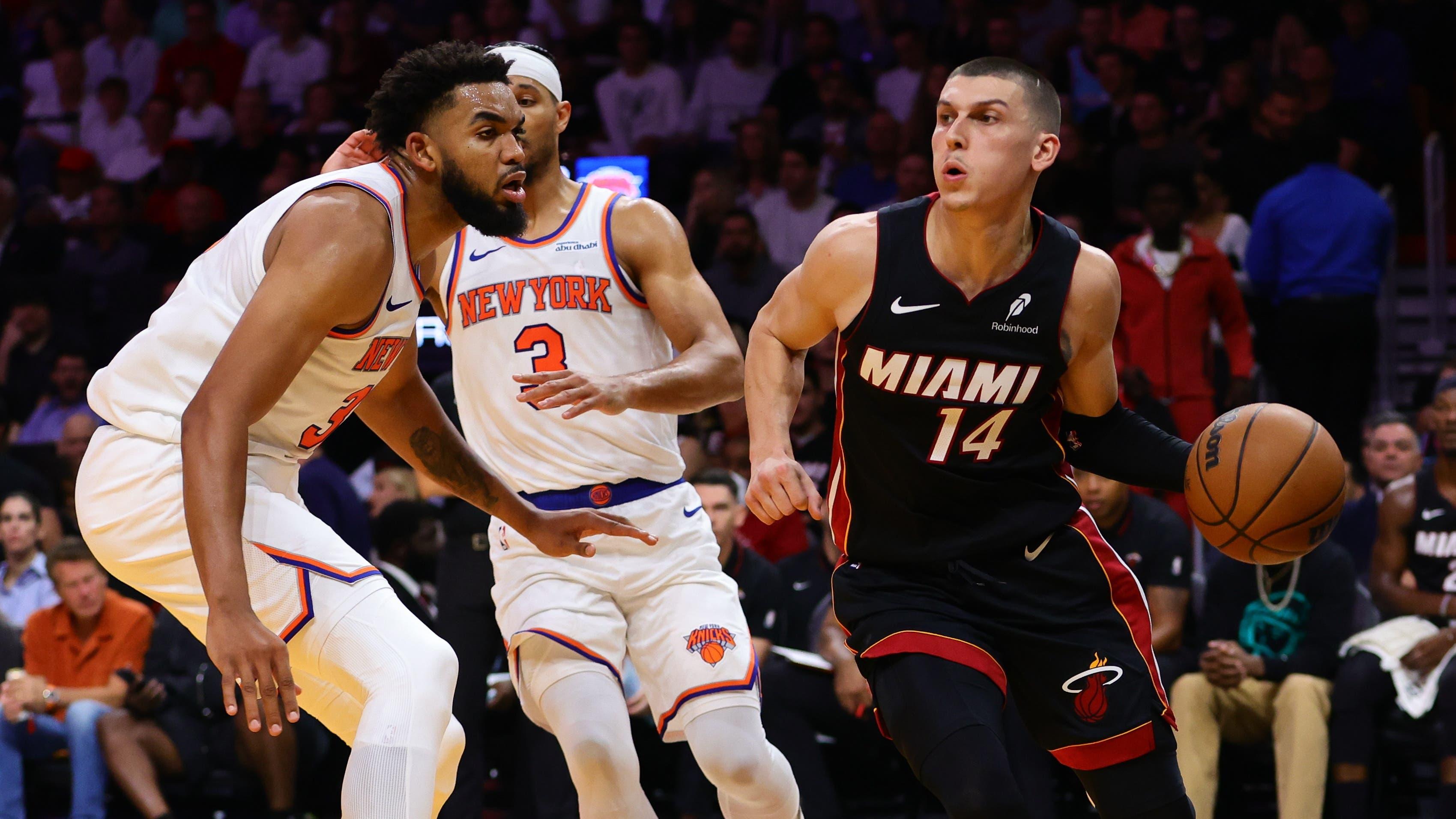 Miami Heat guard Jaime Jaquez Jr. (11) drives to the basket past New York Knicks center Karl-Anthony Towns (32) during the second quarter at Kaseya Center / Sam Navarro - Imagn Images