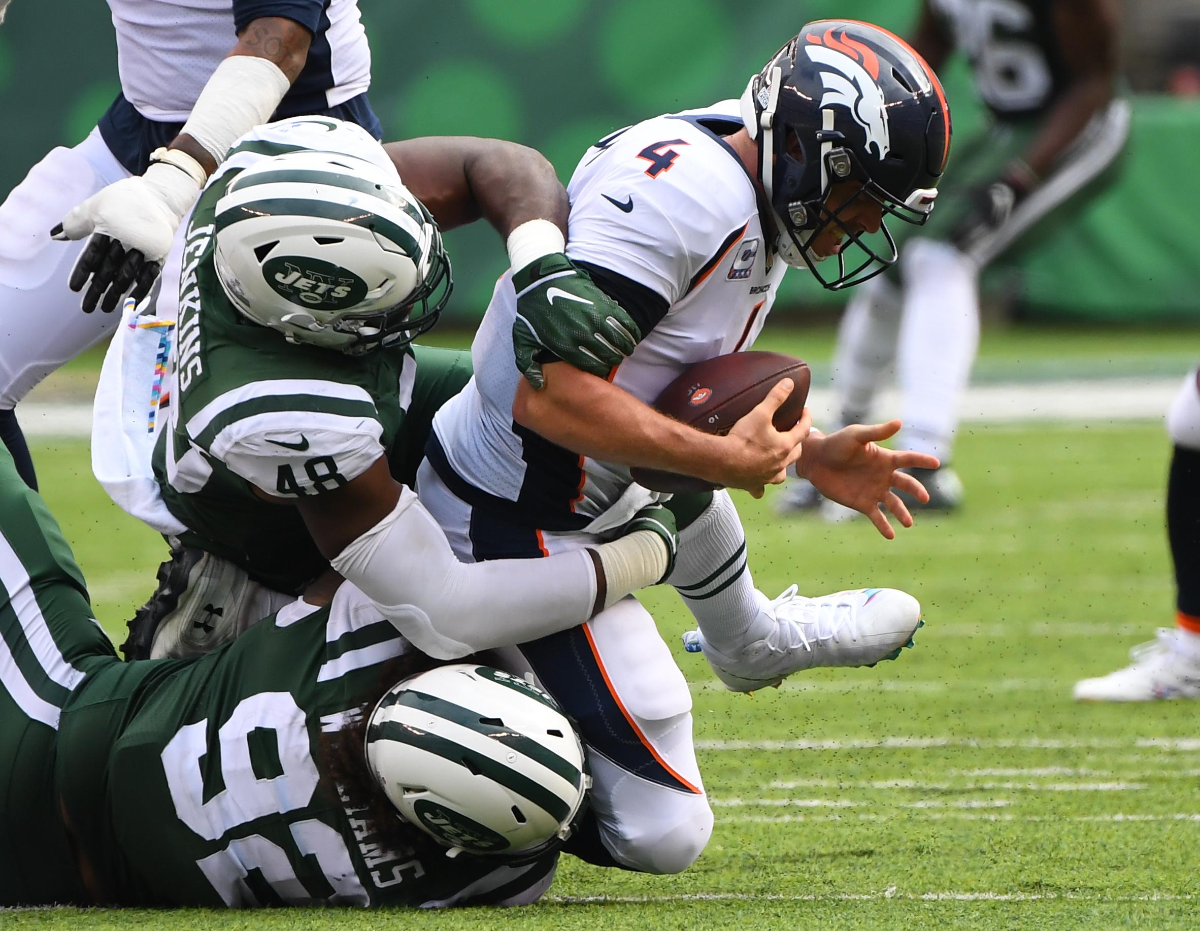 New York Jets defensive end Leonard Williams and Jets linebacker Jordan Jenkins sack Denver Broncos quarterback Case Keenum in the third quarter at MetLife Stadium.