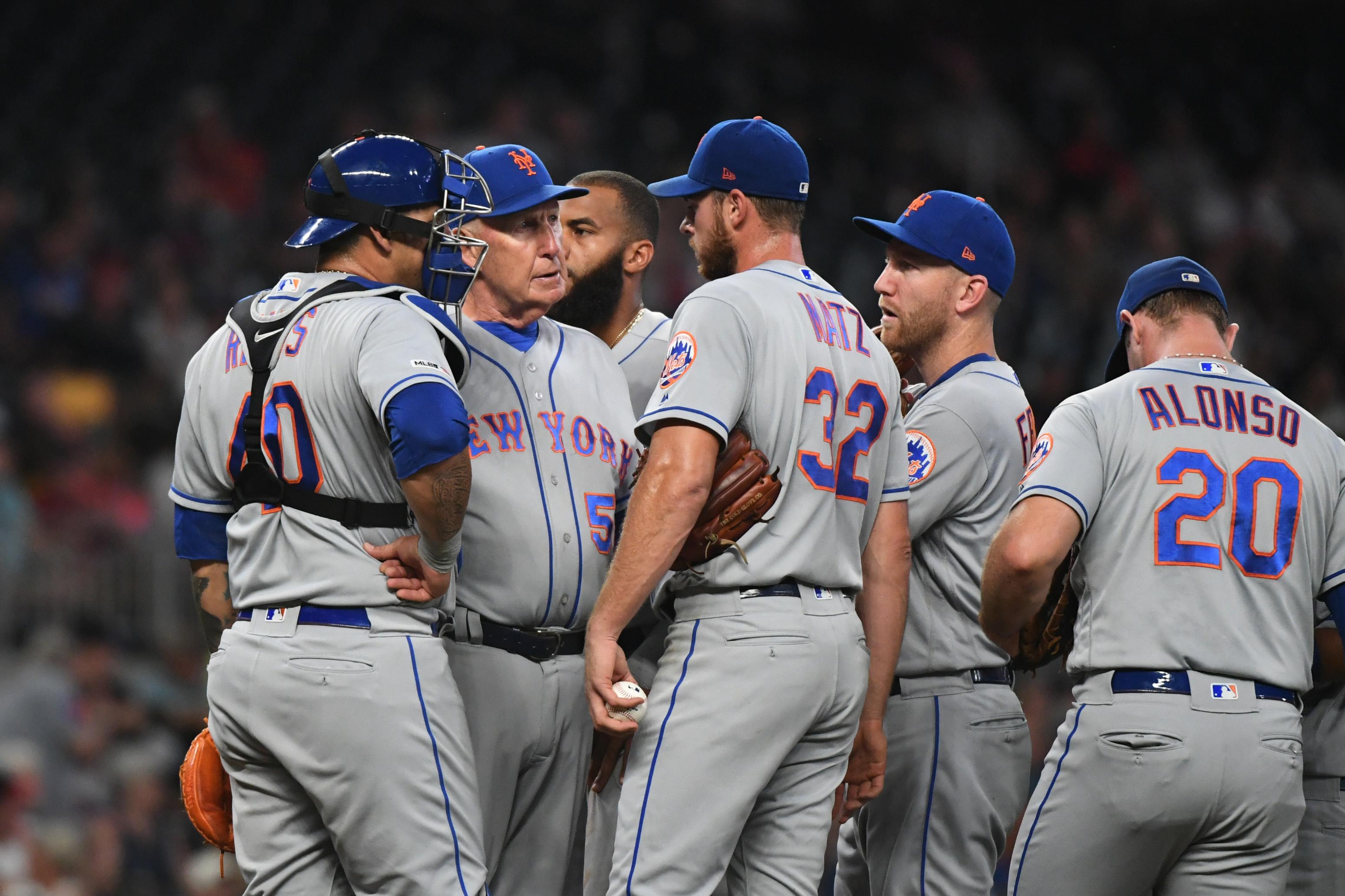 Aug 14, 2019; Cumberland, GA, USA; New York Mets interim pitching coach Phil Regan (58) talks with starting pitcher Steven Matz (32) during the second inning against the Atlanta Braves at SunTrust Park. Mandatory Credit: Adam C. Hagy-USA TODAY Sports