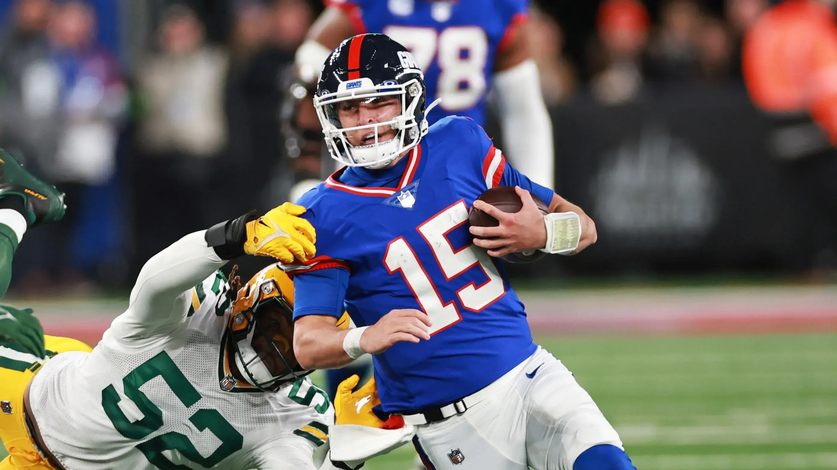 Dec 11, 2023; East Rutherford, New Jersey, USA; New York Giants quarterback Tommy DeVito (15) is tackled by Green Bay Packers linebacker Rashan Gary (52) during the second quarter at MetLife Stadium. Mandatory Credit: Vincent Carchietta-USA TODAY Sports / © Vincent Carchietta-USA TODAY Sports