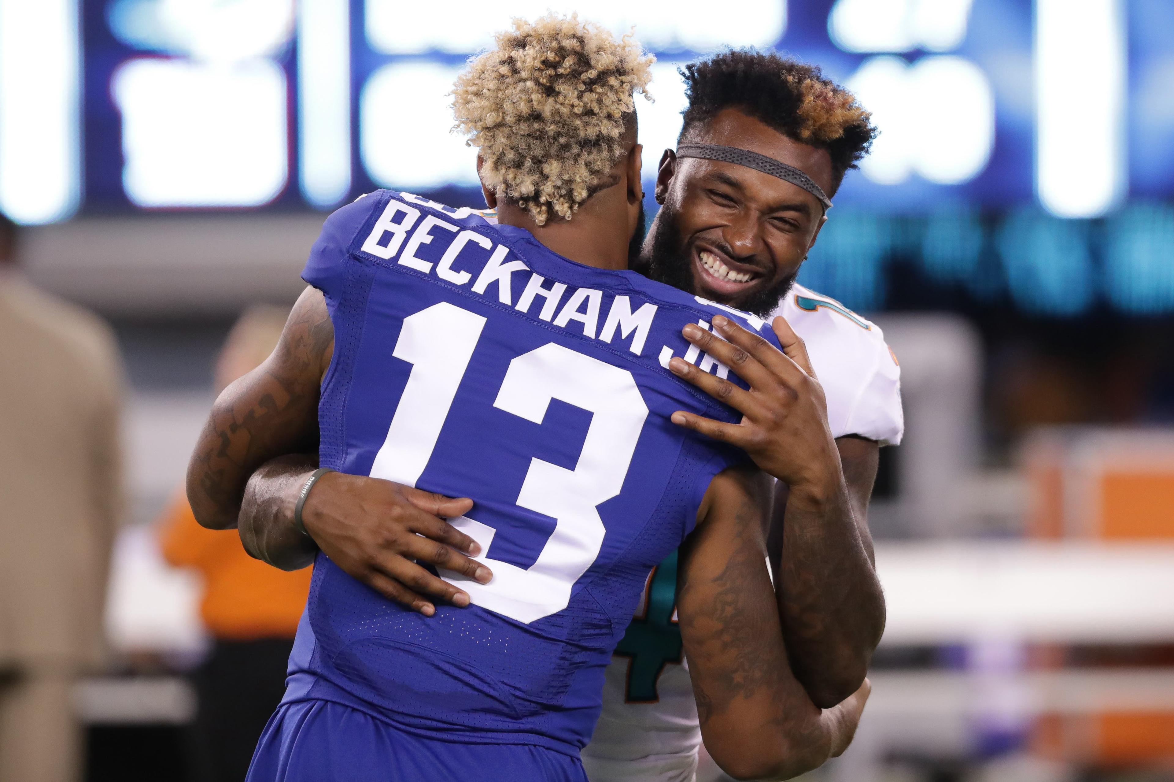 Aug 12, 2016; East Rutherford, NJ, USA; Miami Dolphins wide receiver Jarvis Landry (14) embraces New York Giants wide receiver Odell Beckham (13) after the preseason game at MetLife Stadium. The Dolphins won, 27-10. Mandatory Credit: Vincent Carchietta-USA TODAY Sports / Vincent Carchietta