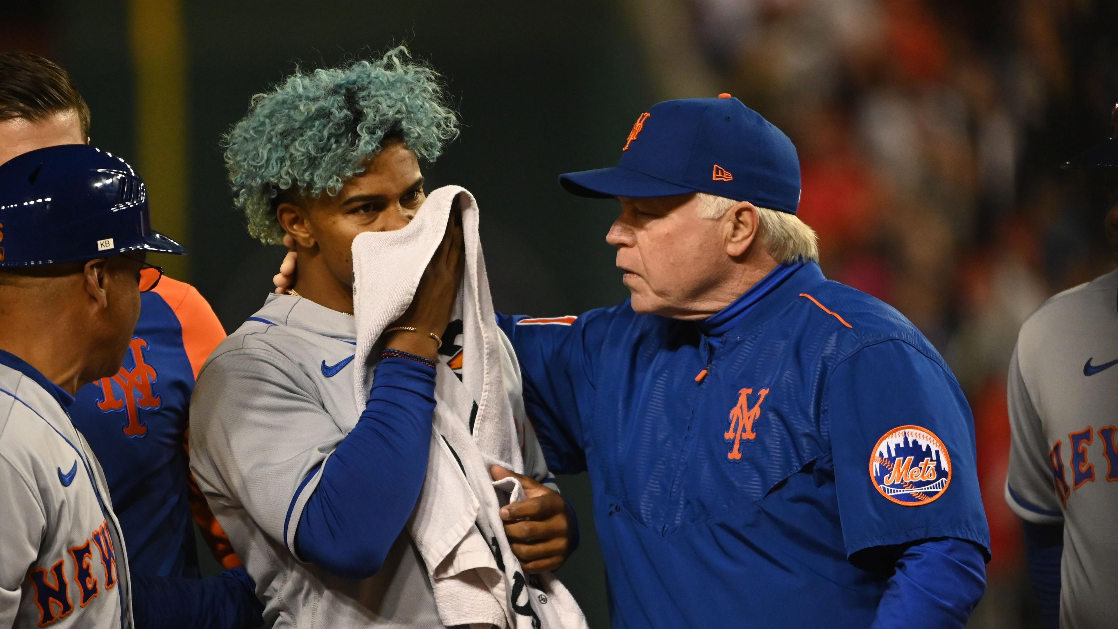 Apr 8, 2022; Washington, District of Columbia, USA; New York Mets shortstop Francisco Lindor (12) covers his face after being hit by pitch while manager Buck Showalter (11) walks with him during the fifth inning against the Washington Nationals at Nationals Park. Mandatory Credit: Tommy Gilligan-USA TODAY Sports / © Tommy Gilligan-USA TODAY Sports