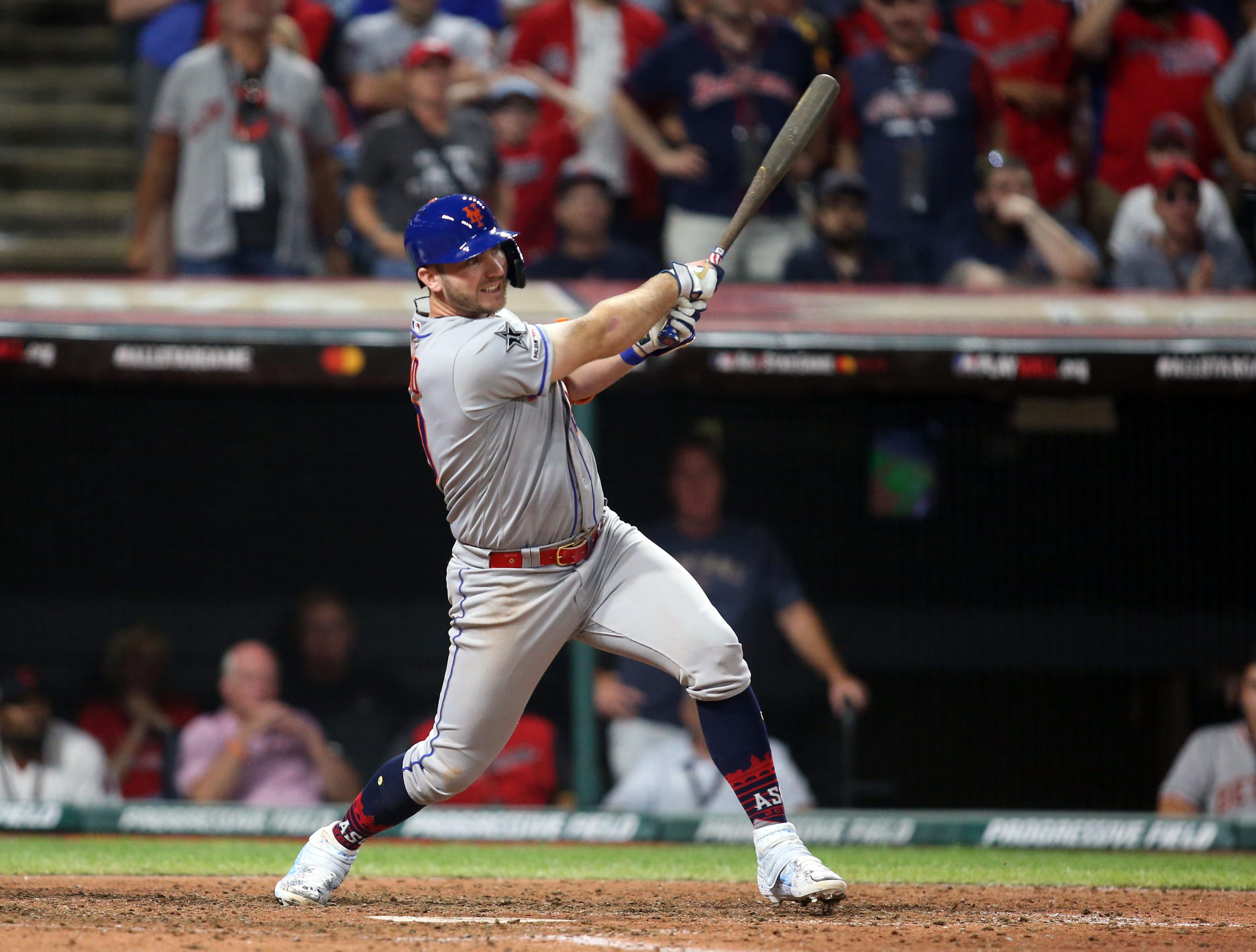 Jul 9, 2019; Cleveland, OH, USA; National League infielder Pete Alonso (20) of the New York Mets hits a 2 RBI single against the American League during the eighth inning in the 2019 MLB All Star Game at Progressive Field. Mandatory Credit: Charles LeClaire-USA TODAY Sports