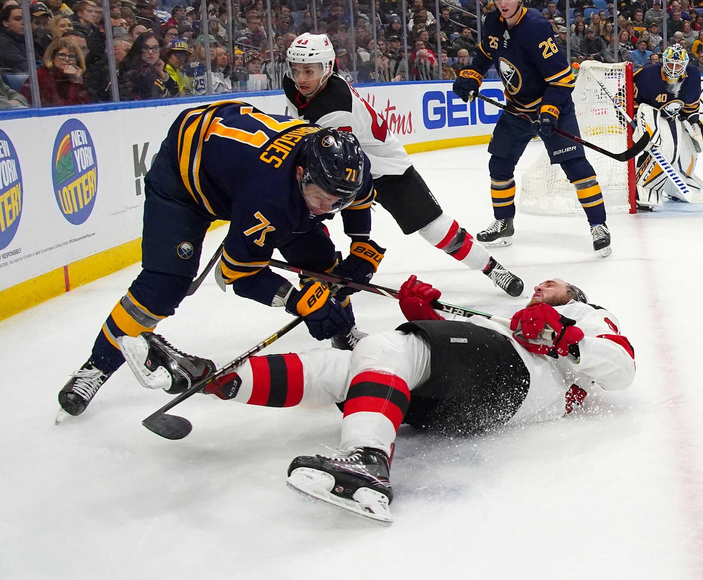 Jan 8, 2019; Buffalo, NY, USA; Buffalo Sabres left wing Evan Rodrigues (71) checks New Jersey Devils right wing Stefan Noesen (23) during the third period at KeyBank Center. Mandatory Credit: Kevin Hoffman-USA TODAY Sports / Kevin Hoffman