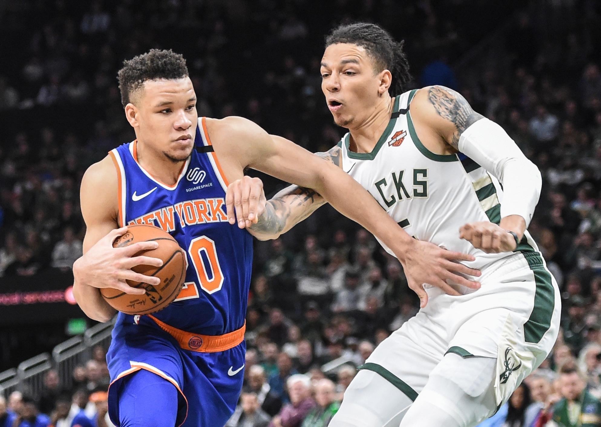 Jan 14, 2020; Milwaukee, Wisconsin, USA; New York Knicks forward Kevin Knox II (20) drives for the basket against Milwaukee Bucks forward D.J. Wilson (5) in the second quarter at Fiserv Forum. Mandatory Credit: Benny Sieu-USA TODAY Sports