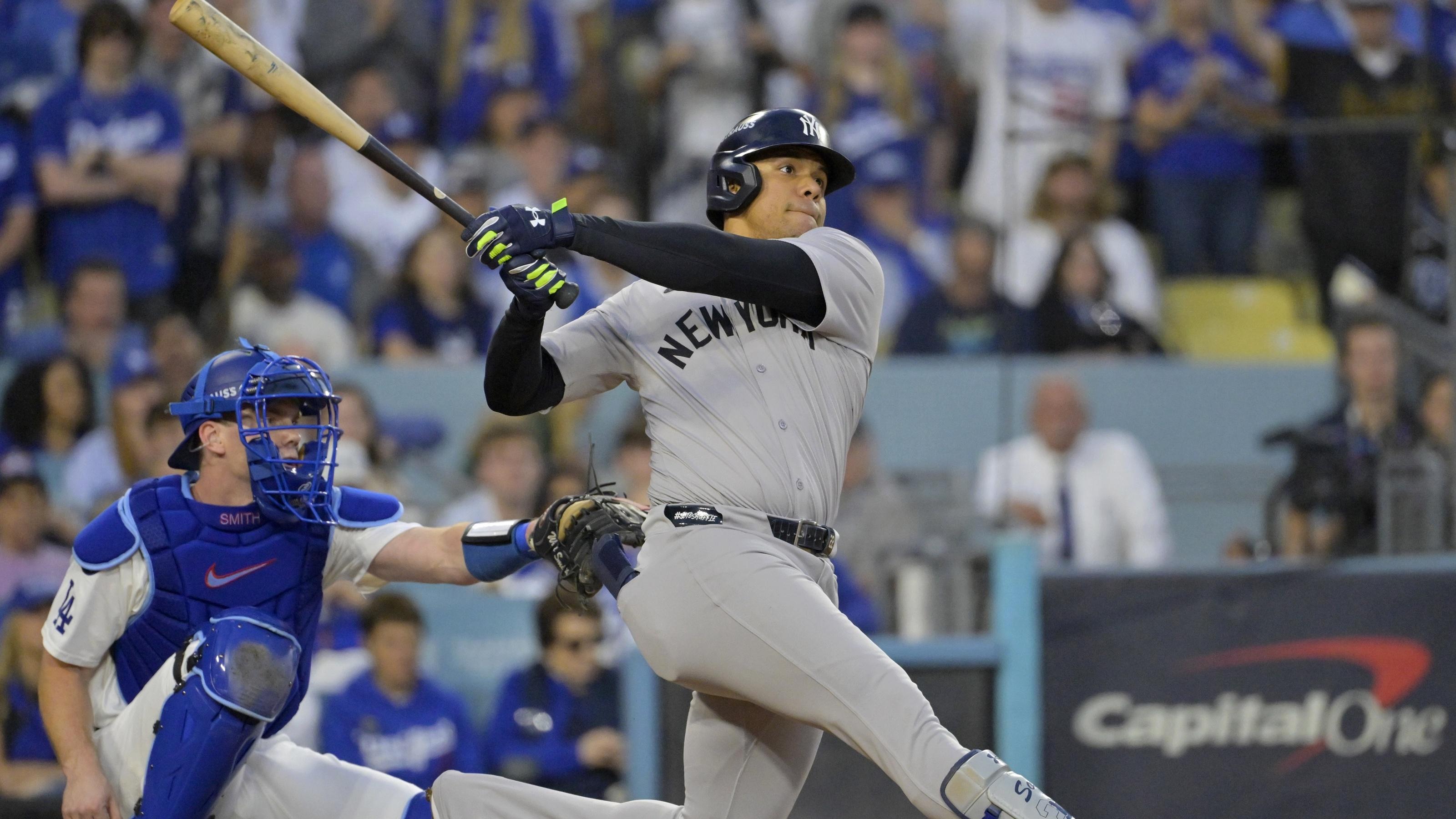 New York Yankees outfielder Juan Soto (22) hits a solo home run in the third inning against the Los Angeles Dodgers during game two of the 2024 MLB World Series at Dodger Stadium.