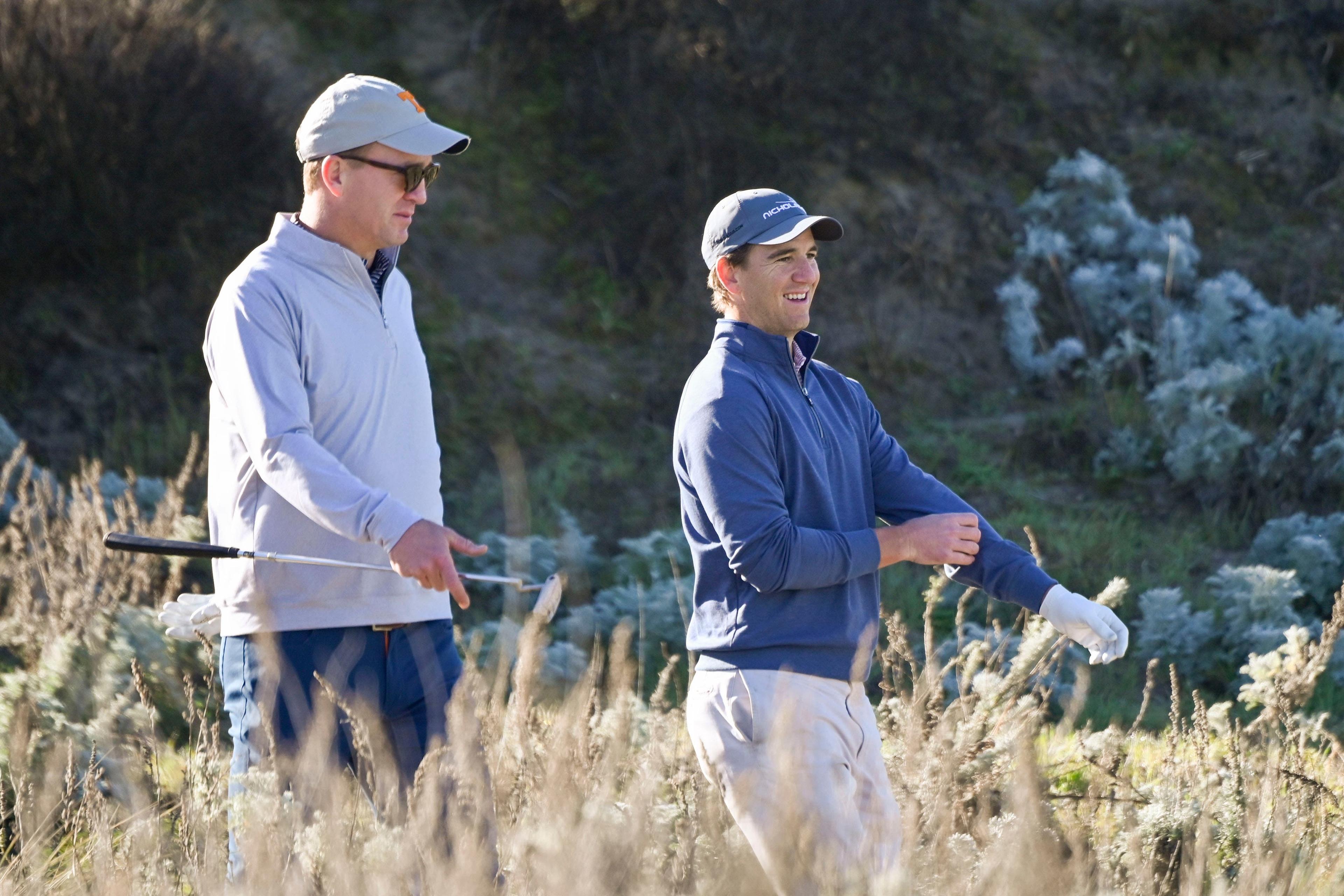 February 6, 2020; Pebble Beach, California, USA; Peyton Manning (left) and Eli Manning (right) walk on the third hole during the first round of the AT&T Pebble Beach Pro-Am golf tournament at Spyglass Hill Golf Course. Mandatory Credit: Michael Madrid-USA TODAY Sports / Michael Madrid