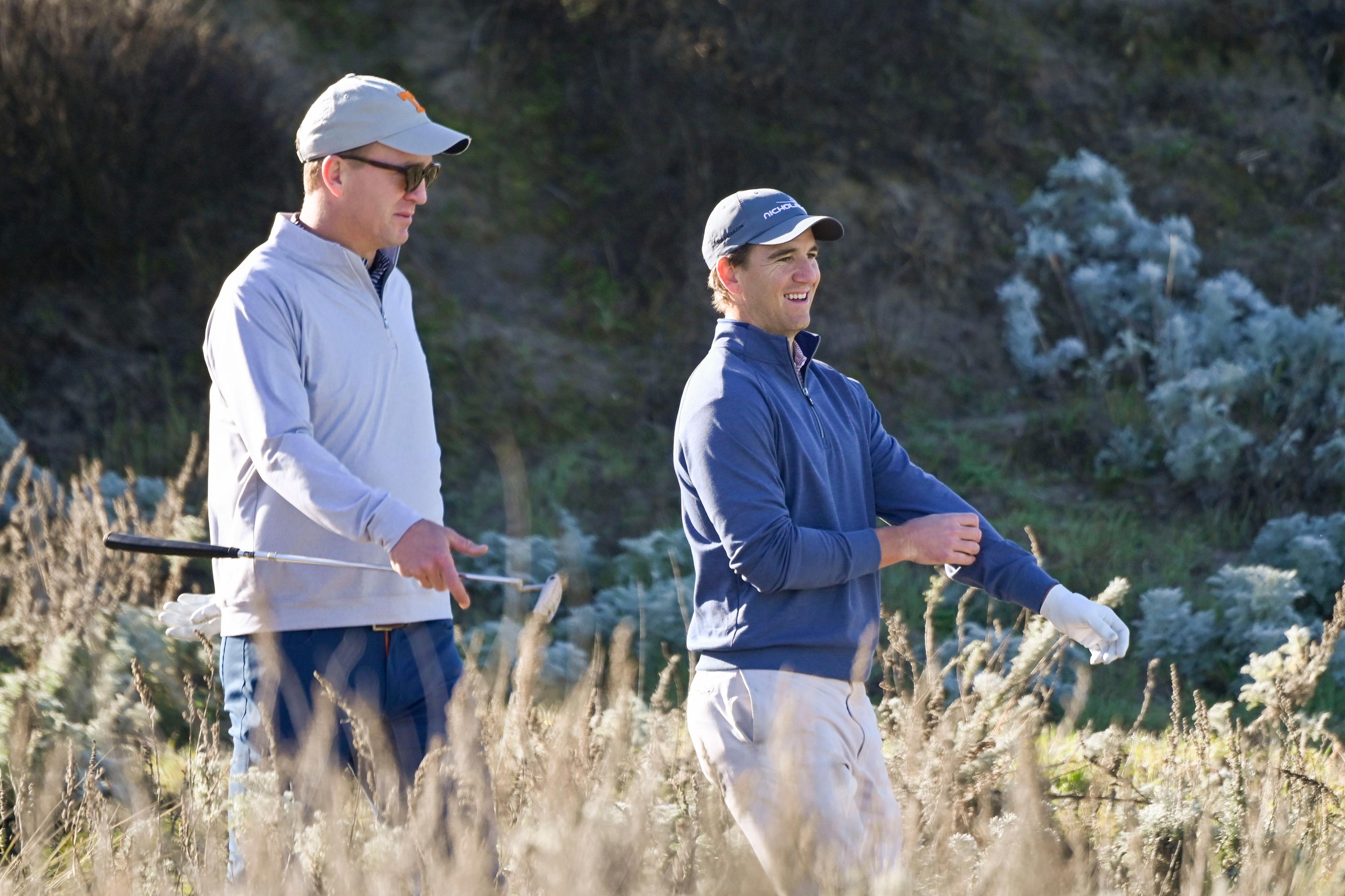 February 6, 2020; Pebble Beach, California, USA; Peyton Manning (left) and Eli Manning (right) walk on the third hole during the first round of the AT&T Pebble Beach Pro-Am golf tournament at Spyglass Hill Golf Course. Mandatory Credit: Michael Madrid-USA TODAY Sports