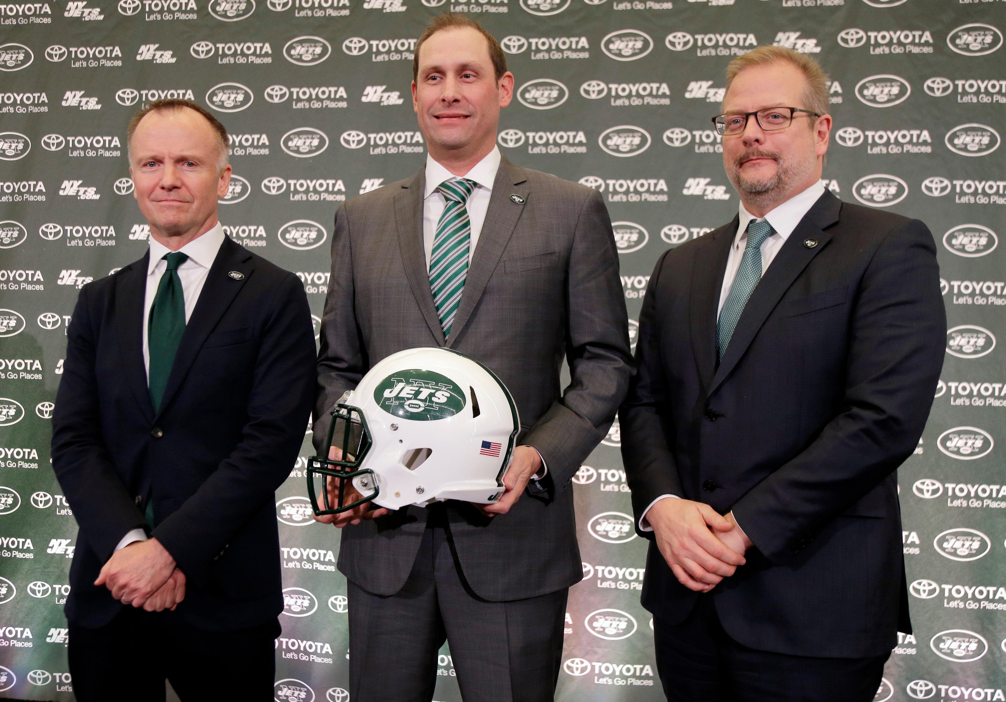 New York Jets head coach Adam Gase, center, poses for a picture with owner Christopher Johnson, left, and general manager Mike Maccagnan pose for a picture during a news conference in Florham Park, N.J., Monday, Jan. 14, 2019. (AP Photo/Seth Wenig)