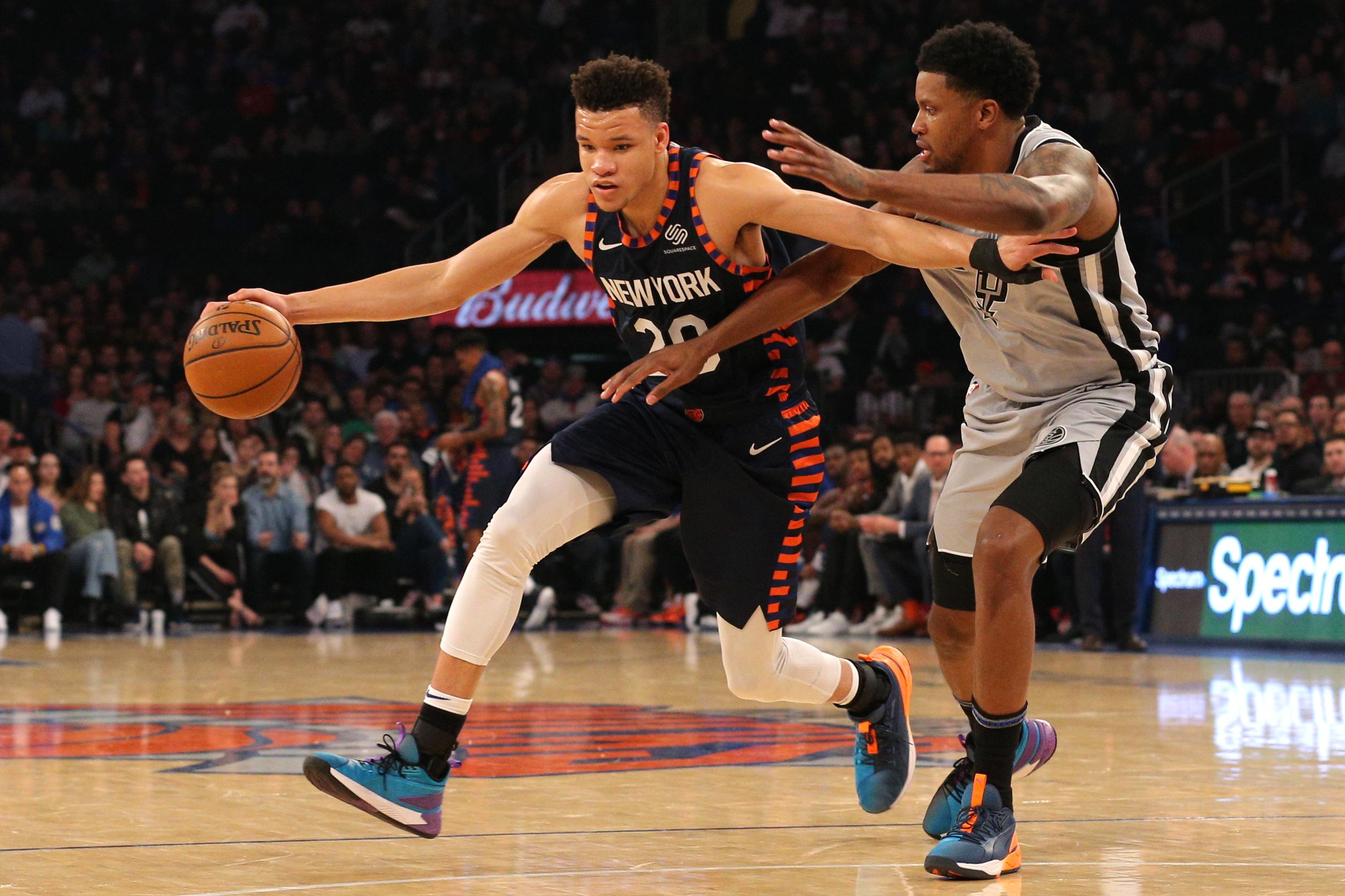 New York Knicks small forward Kevin Knox controls the ball against San Antonio Spurs small forward Rudy Gay during the first quarter at Madison Square Garden.