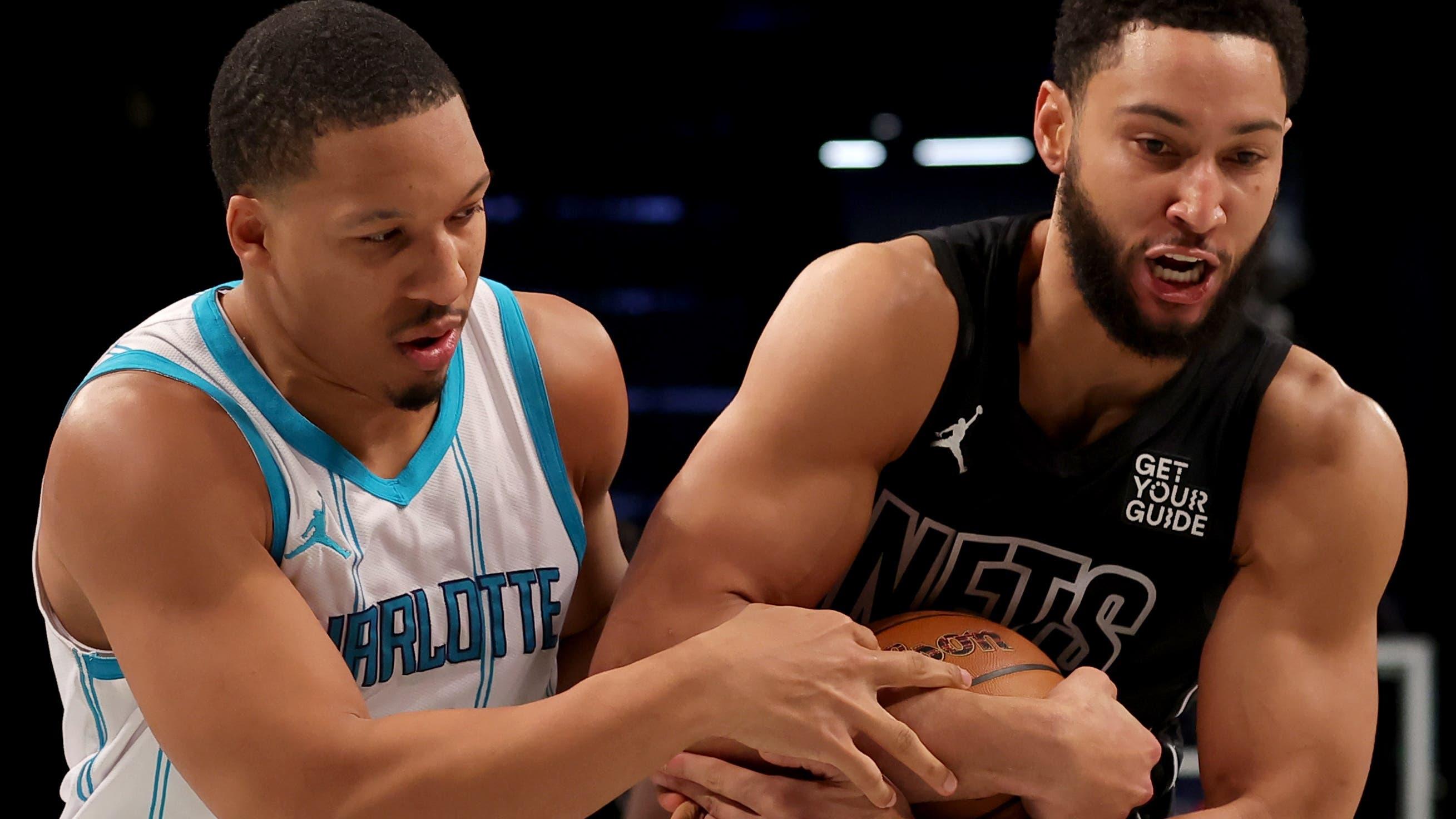 Brooklyn Nets guard Ben Simmons (10) fights for the ball against Charlotte Hornets forward Grant Williams (2) during the second quarter at Barclays Center / Brad Penner - Imagn Images