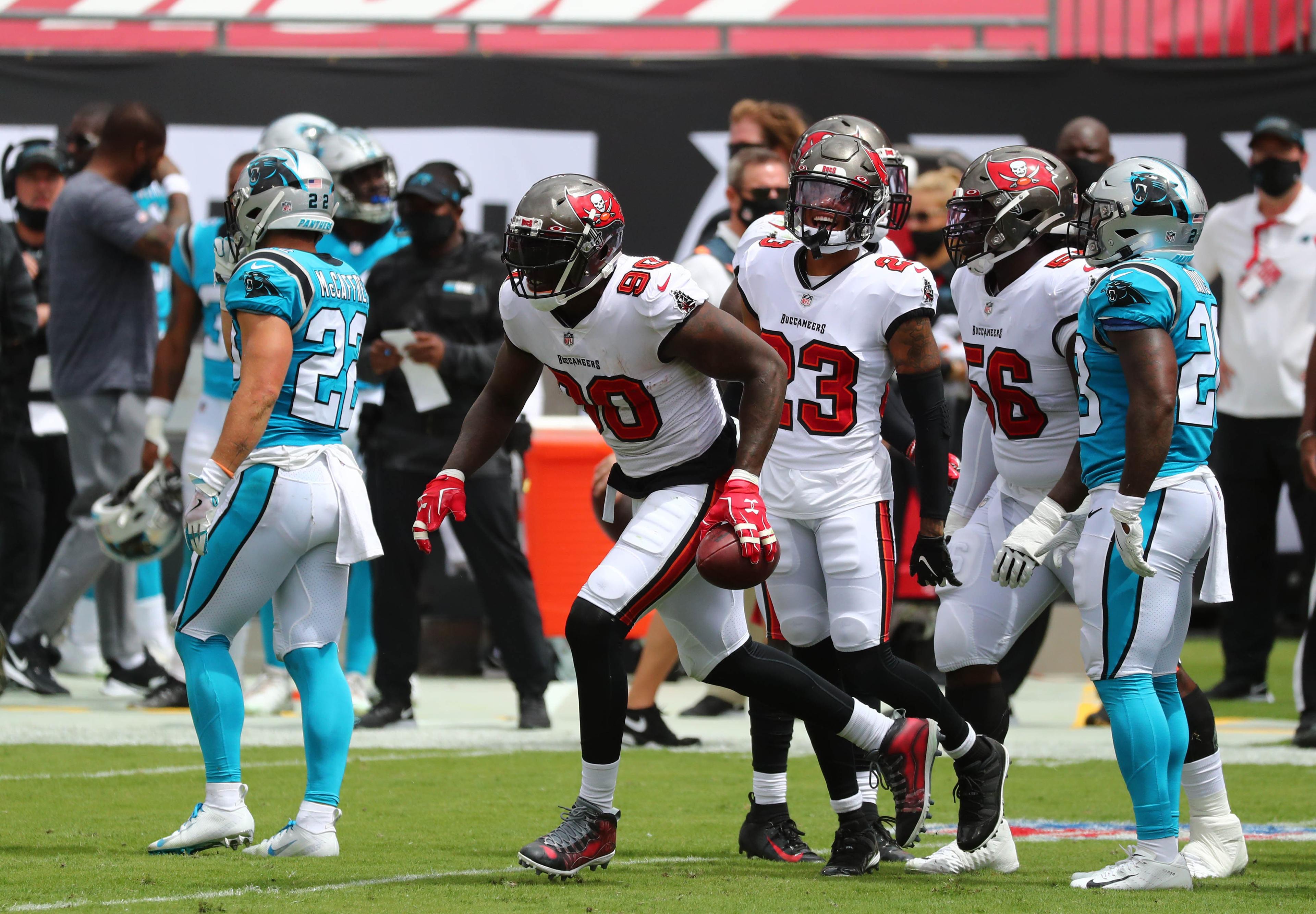 Sep 20, 2020; Tampa, Florida, USA; Tampa Bay Buccaneers defensive end Jason Pierre-Paul (90) celebrates with teammates after recovering a fumble against the Carolina Panthers during the first quarter at Raymond James Stadium. / © Kim Klement-USA TODAY Sports