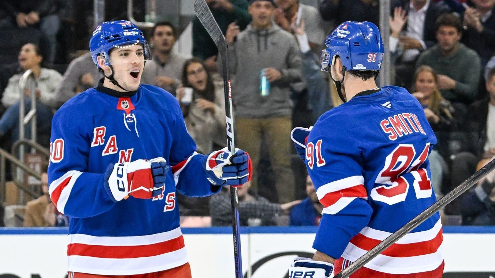 Oct 14, 2024; New York, New York, USA; New York Rangers defenseman Victor Mancini (90) celebrates the goal by New York Rangers right wing Reilly Smith (91) against the Detroit Red Wings during the third period at Madison Square Garden.