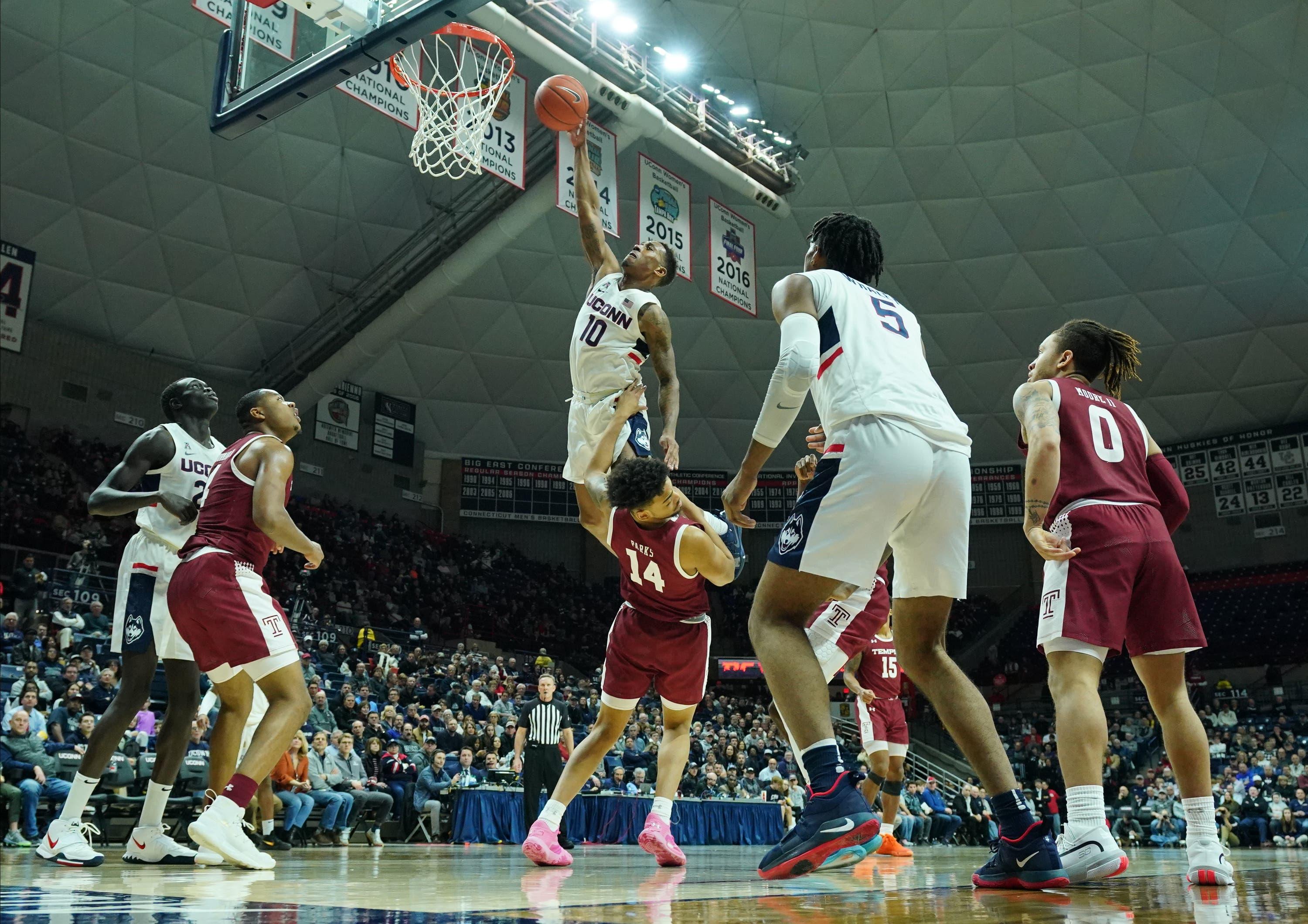 Jan 29, 2020; Storrs, Connecticut, USA; Connecticut Huskies guard Brendan Adams (10) drives the ball over Temple Owls forward Arashma Parks (14) in the first half at Harry A. Gampel Pavilion. Mandatory Credit: David Butler II-USA TODAY Sports / David Butler II