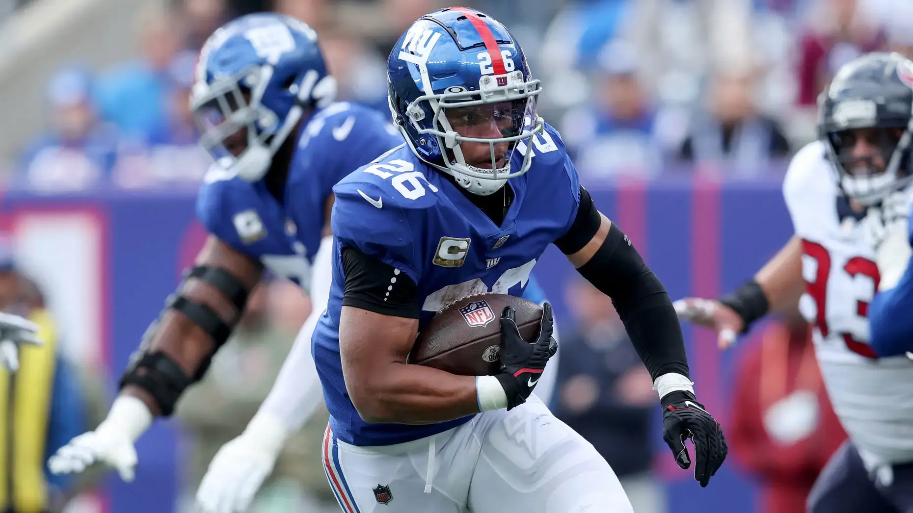 Nov 13, 2022; East Rutherford, New Jersey, USA; New York Giants running back Saquon Barkley (26) runs with the ball against the Houston Texans during the first quarter at MetLife Stadium. / Brad Penner-USA TODAY Sports