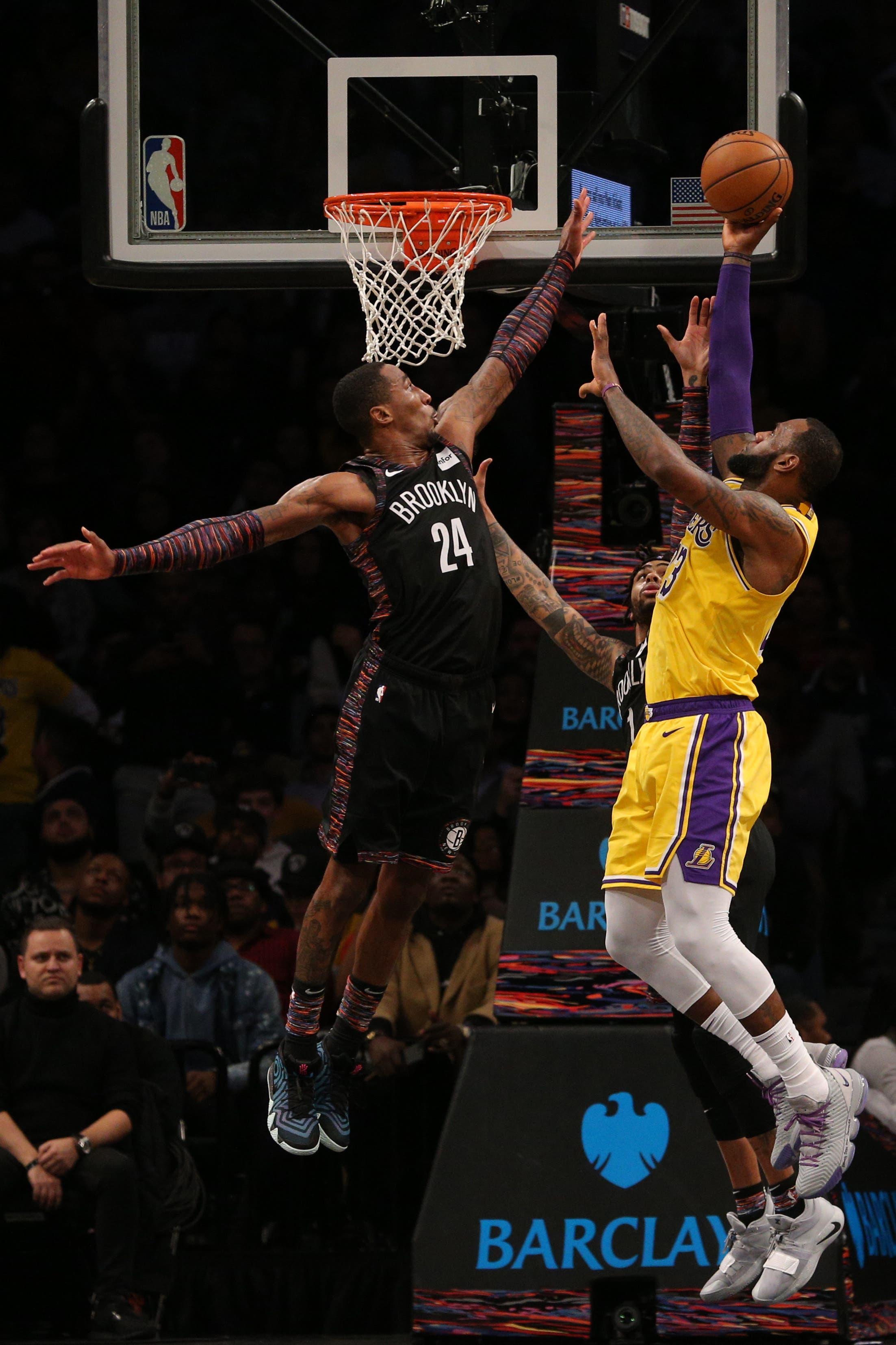 Los Angeles Lakers small forward LeBron James shoots against Brooklyn Nets small forward Rondae Hollis-Jefferson and point guard D'Angelo Russell during the fourth quarter at Barclays Center. / Brad Penner/USA TODAY Sports